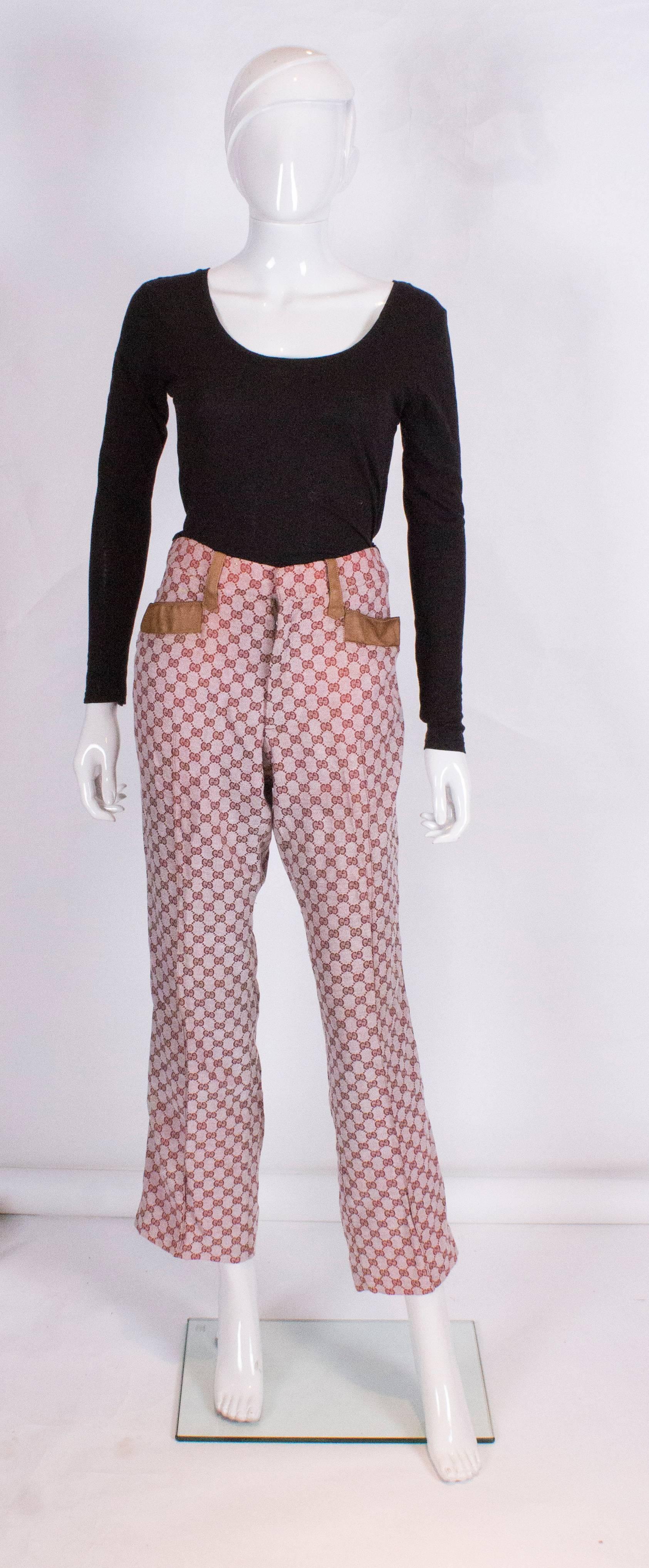 A great pair of pants from Gucci. They are made of Gucci logo fabric with a leather trim. The trim is on the two front pockets and a strip of leather down the outside seam - very now.

Measurements: waist 32'', inside leg 29'', hem 1/12'',  hips 38''