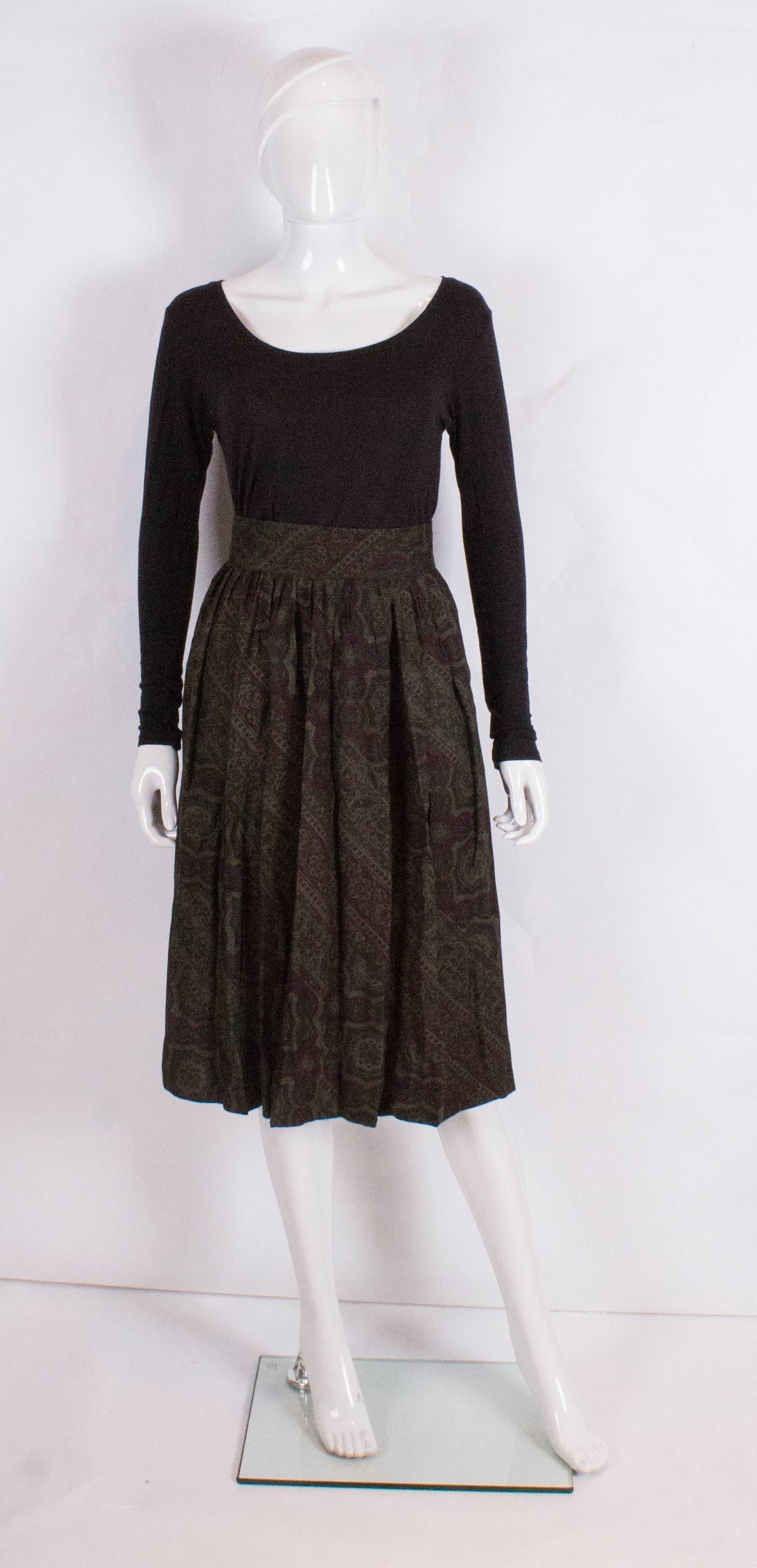A great skirt for Fall. This skirt is a silk/wool mix ( wool 70% , silk 30%), in a green and burgundy print . It has a 3