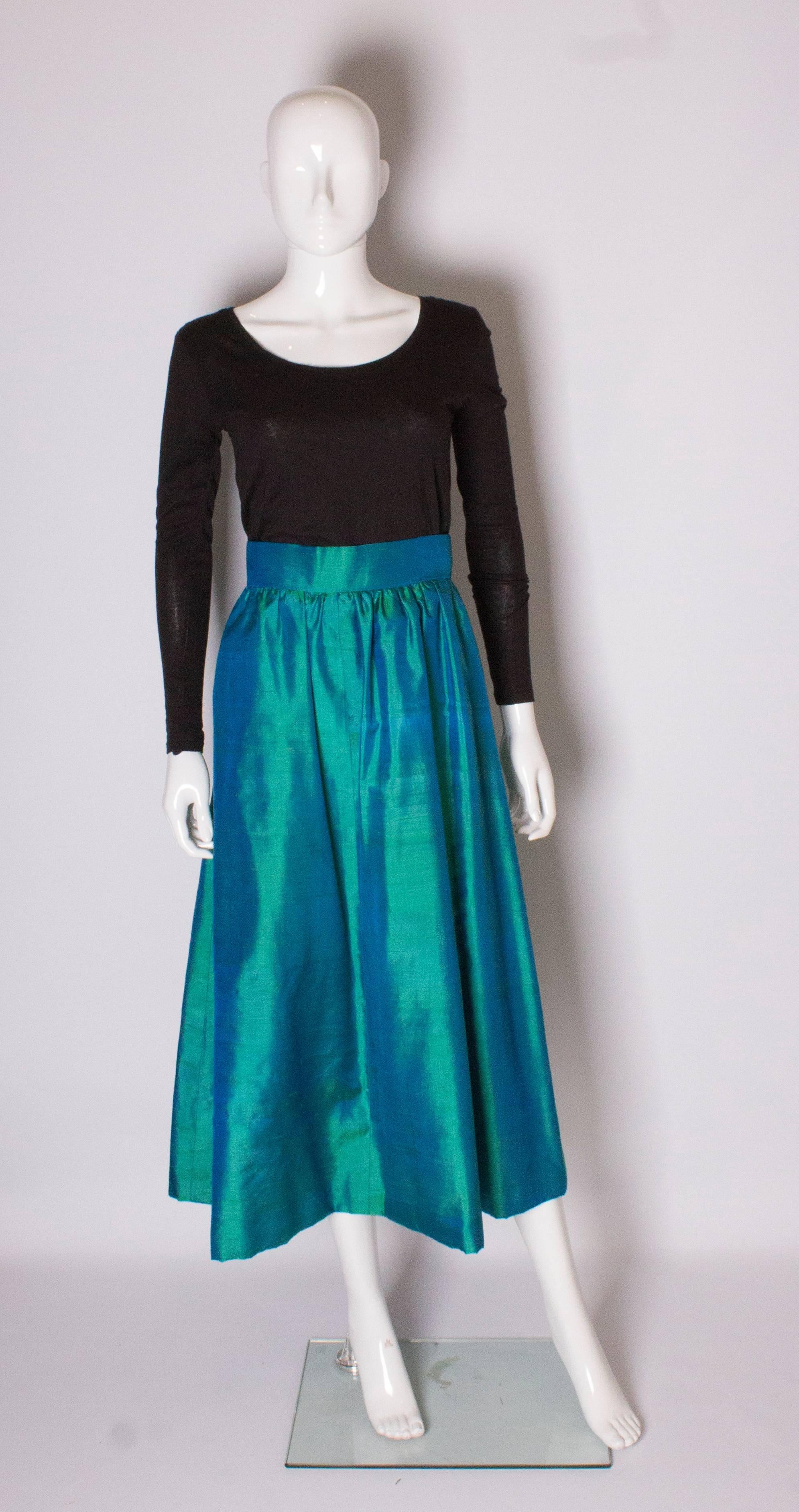 A great see green raw silk skirt. The skirt is gathered at the waist , and has a central back zip.