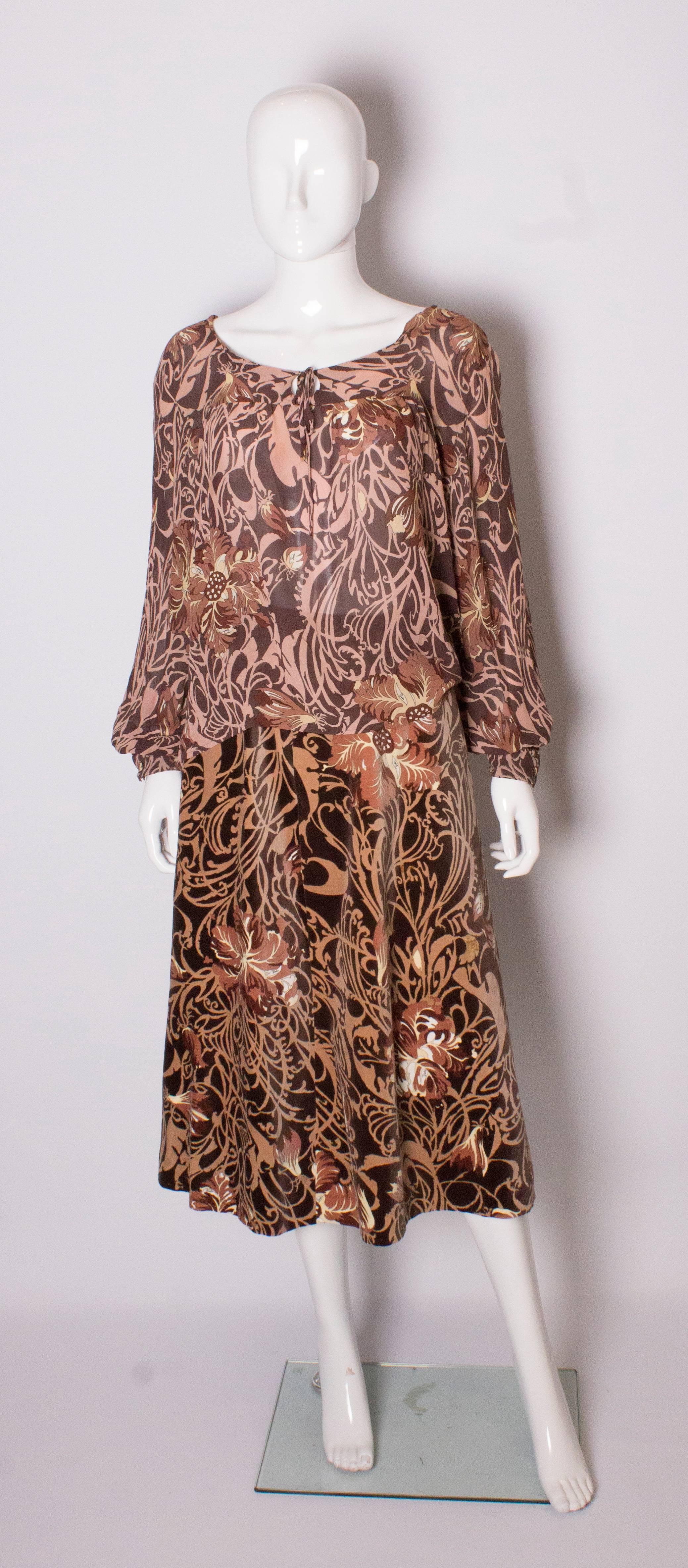 A great print for Fall from Pucci. This outfit has a velvet skirt ( fully lined) with a size zip, and a silk blouse in the same print. The blouse has a tie neck and single button cuffs.
Skirt, waist 28'', length 33',  blouse bust 39'', length 24''