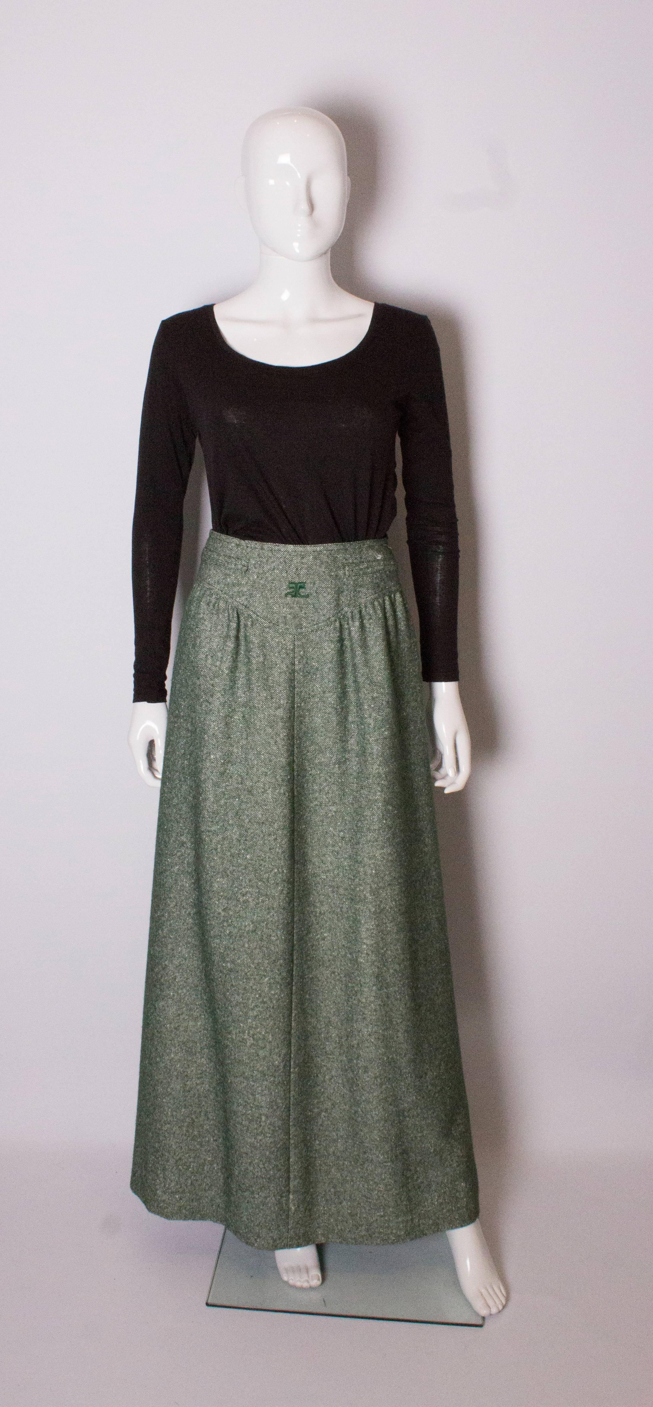 A great skirt for Fall /Winter by Courreges. The skirt is in a green and white, tweed like wool mix , and fully lined.  It has gathering from bellow the wasit band so is very flatterting and has side zip.