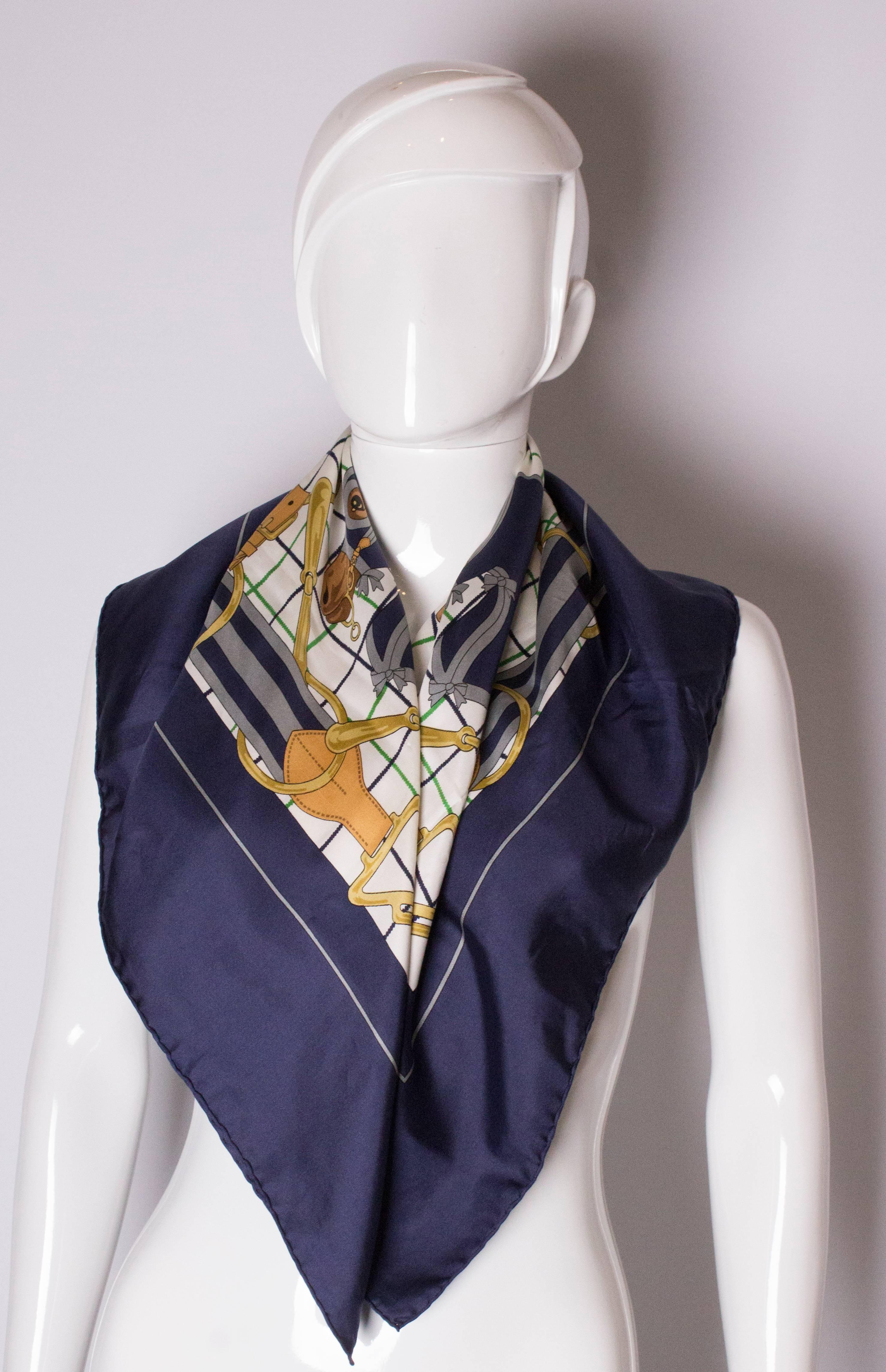 Vintage Silk  Scarf by Hermes, Selliers design. The scarf has a blue border and blue gold and green design.
