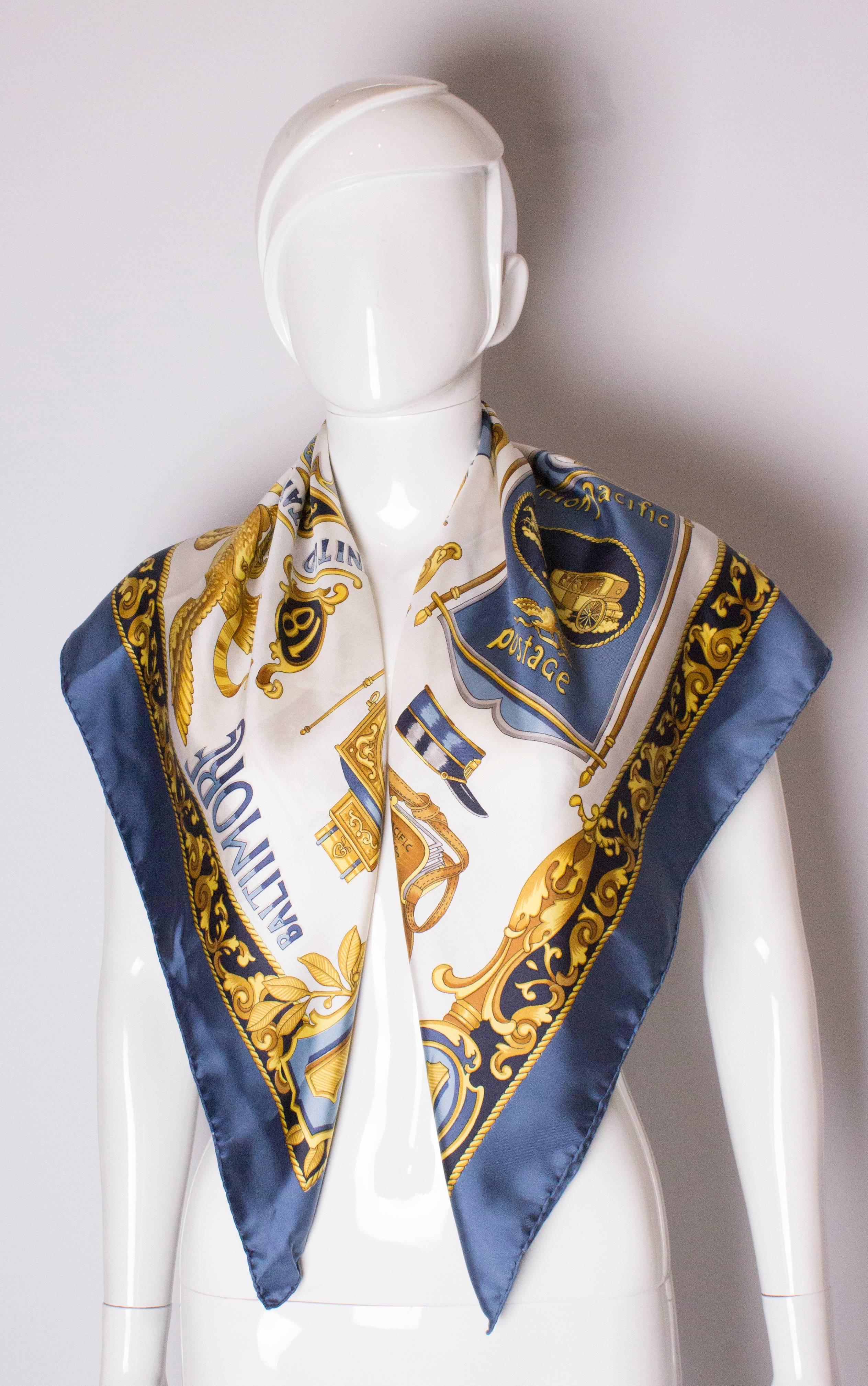 A super silk scarf by Celine. This scarf has a petrol blue border , and is titled the Baltimore and Ohio railway. The scarf measured 36'' square.