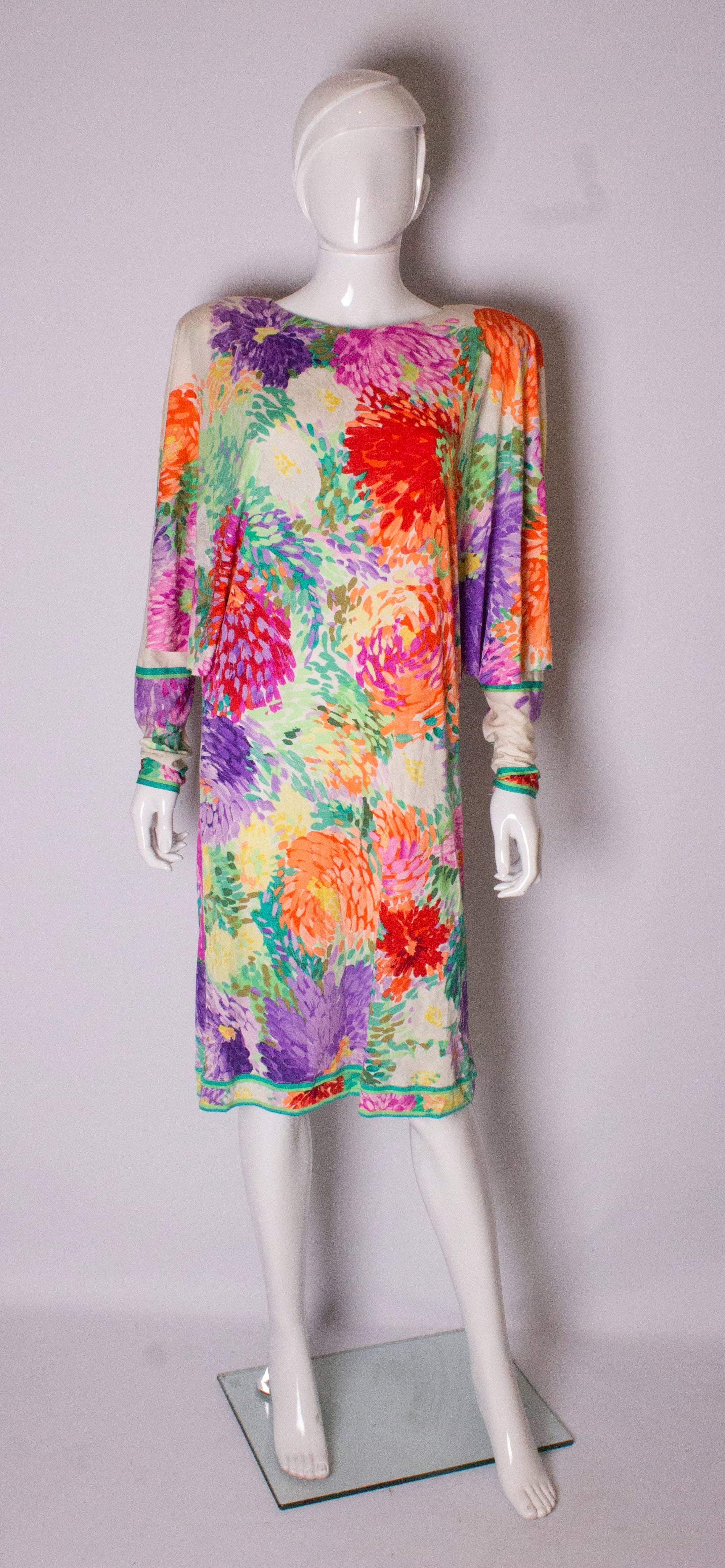 A wonderful dress by Leonard,in a typical vibrant floral print. The dress has great sleeves , a central back zip. It is open under the arm but this can be sewn up if required.