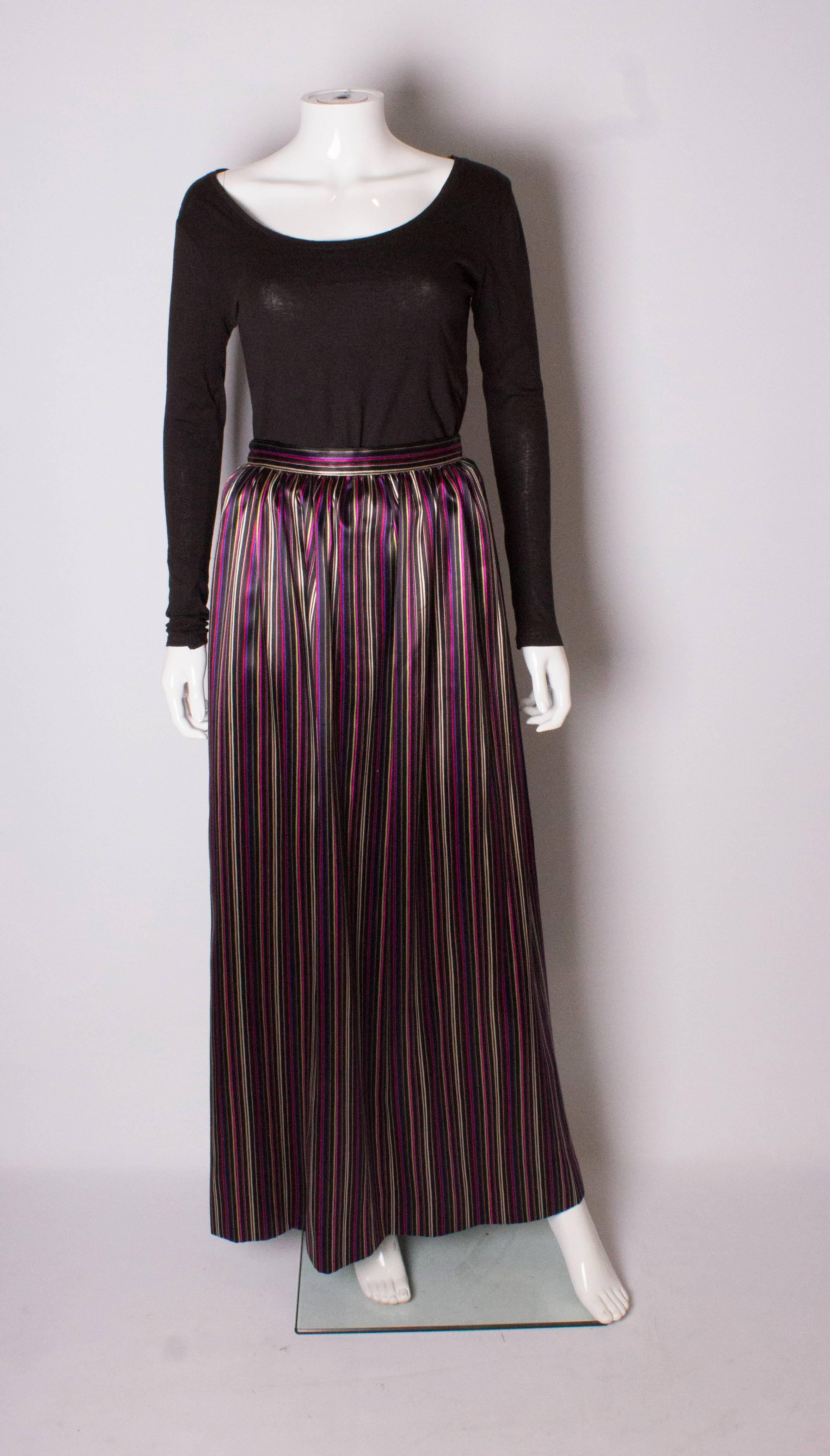 A chic stripe skirt by Givenchy. This full length skirt, has a black background with multicolour vertical  stripes.The  skirt has zip on the left hand side.