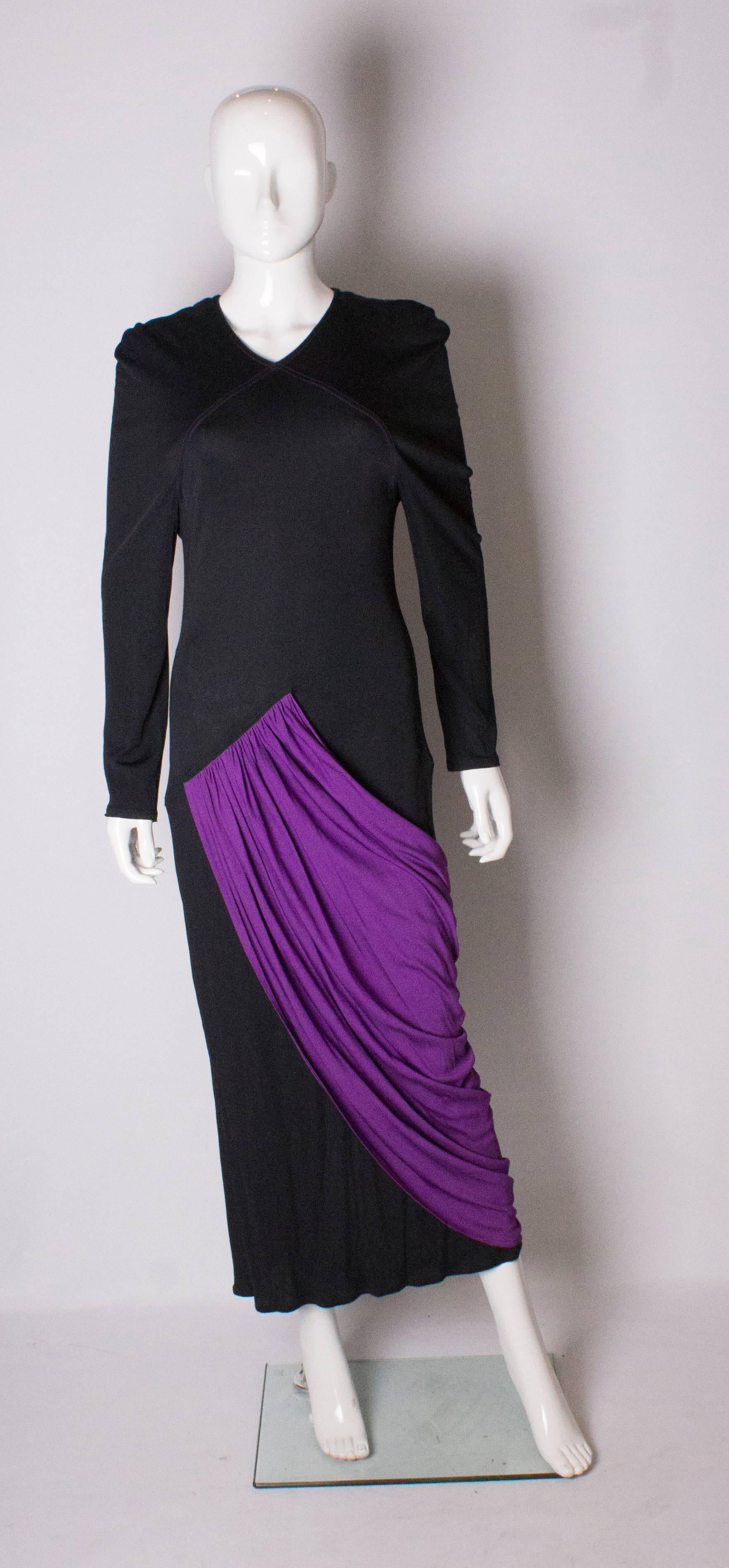  A great gown by Bruce Oldfield. The dress has a v neckline with a purple pleated over skirt.- front and back. The dress has a 14 1/2 