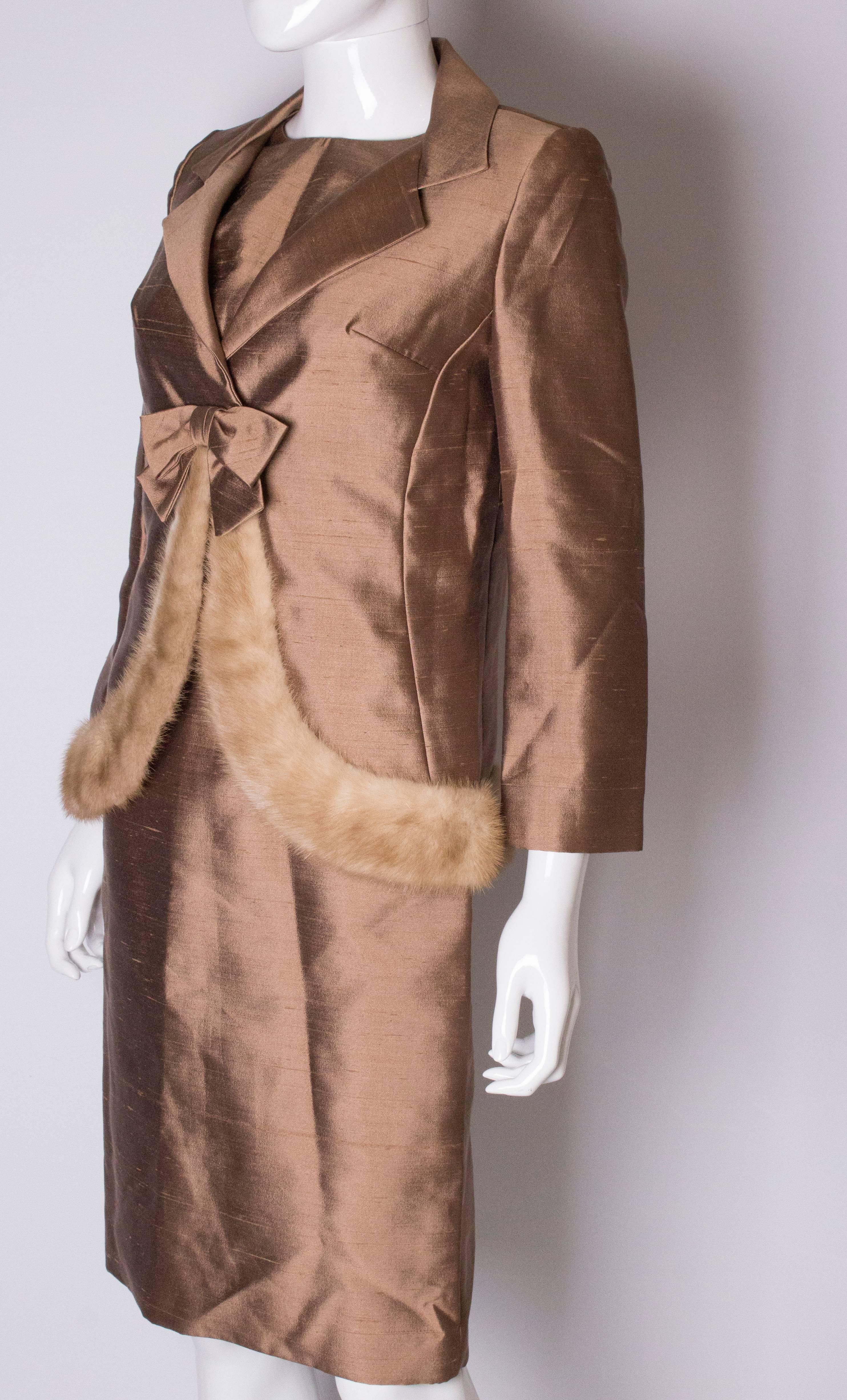 A chic outfit by The Beverely Shop in Springfield , Massachsutus. The shift dress is tailored, sleeveless and fully lined. The jacket has a single fastening at the front and is trimmed with mink at the hem. It is fully lined.
Measurements: Jacket