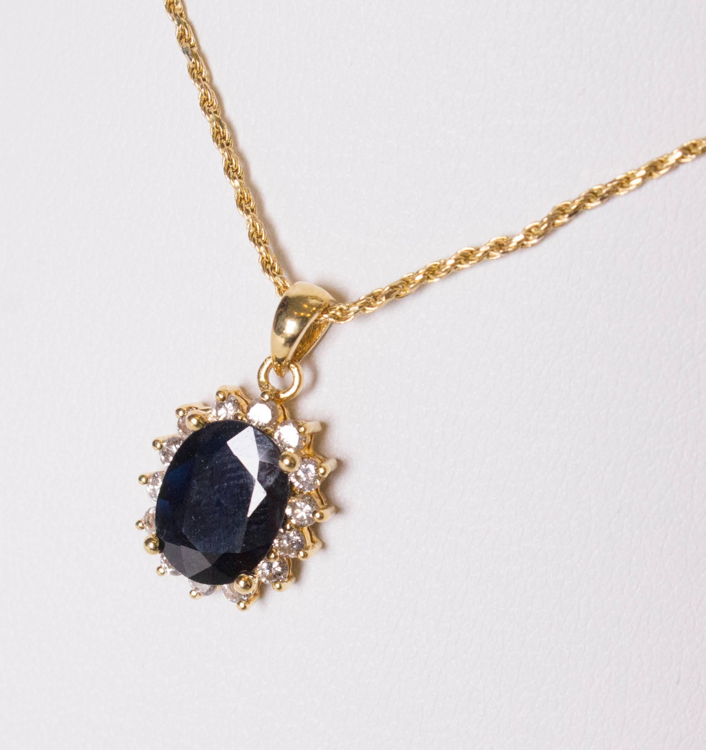 A lovely pendant , of an oval sapphire surrounded by a row of diamonds  and set in yellow gold. Saphire 2.45ct, 14 diamonds total 0.42cts.
The pendant measure , 3/8'' wide by 4/8'' high