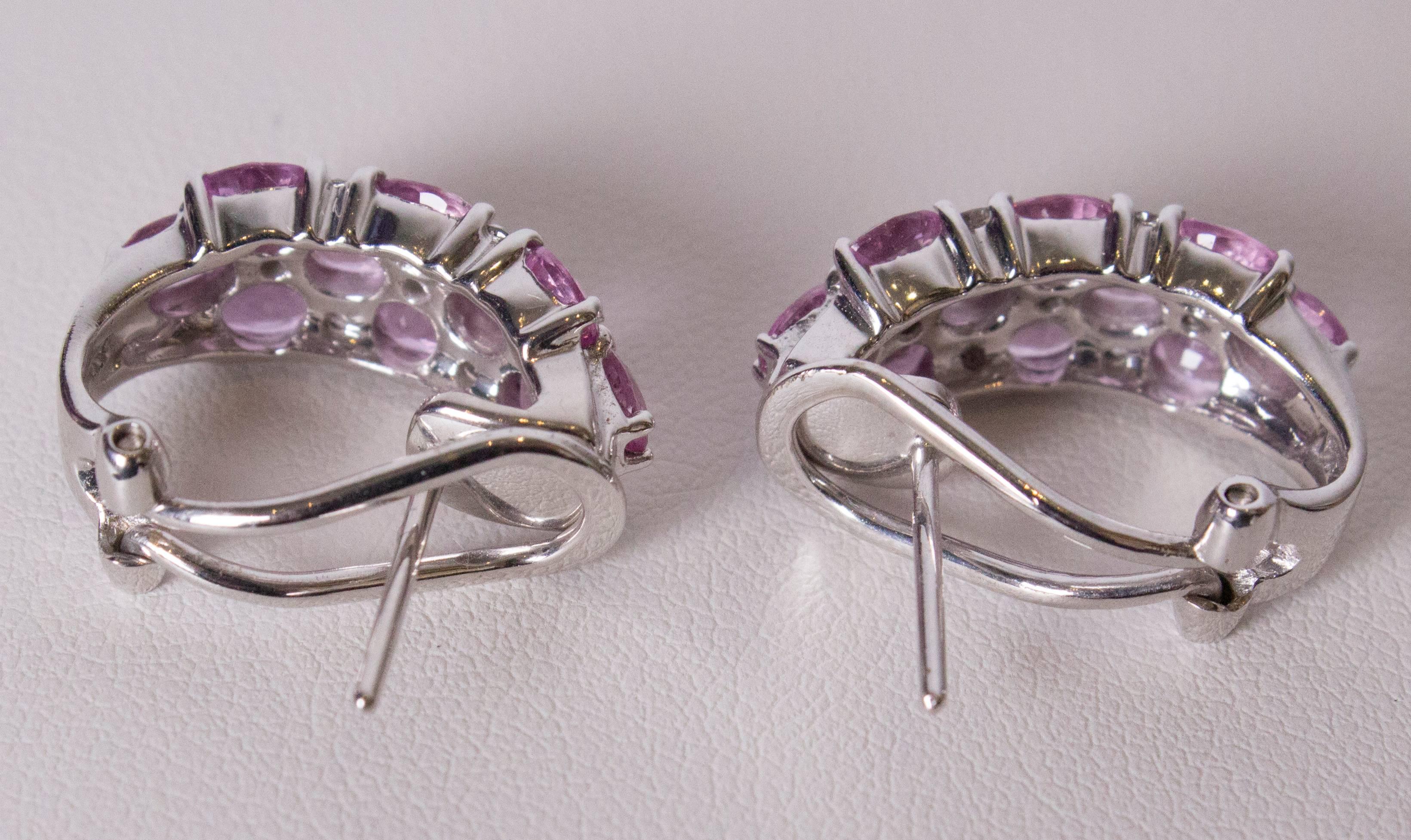 A pretty pair of earrings for Summer. The diamonds and pink sapphires are set alternately in three rows, in white gold with a  lever clip at the back. Height 3/4'', width 3/8''