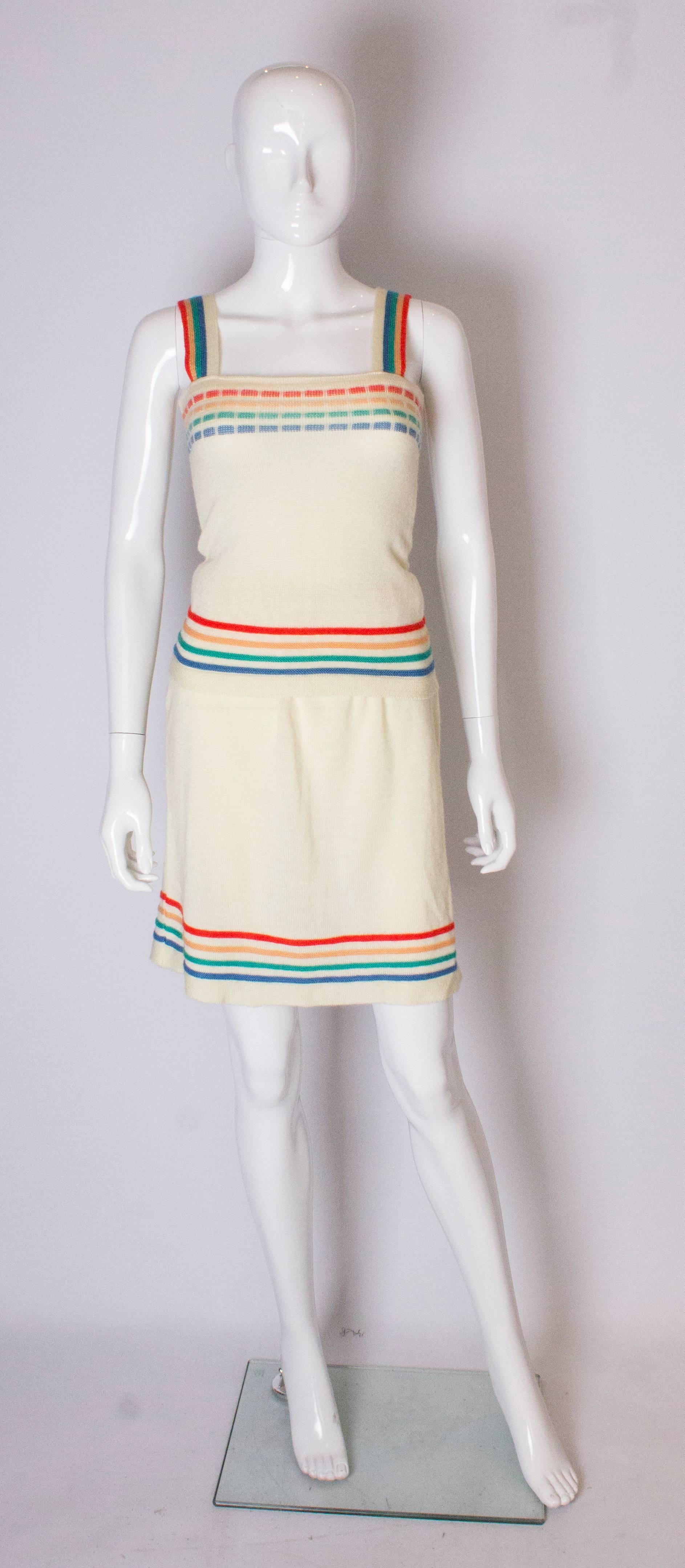 A fun 1960s vintage knitwear two piece outfit for Spring. The top is cream with coloured stripes and shoulder straps, and the skirt has an elasticated waist .The skirt will fit a waist up to 30''