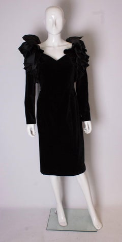A Vintage 1980s dramatic sleeve black cocktail dress by Gina Fratini