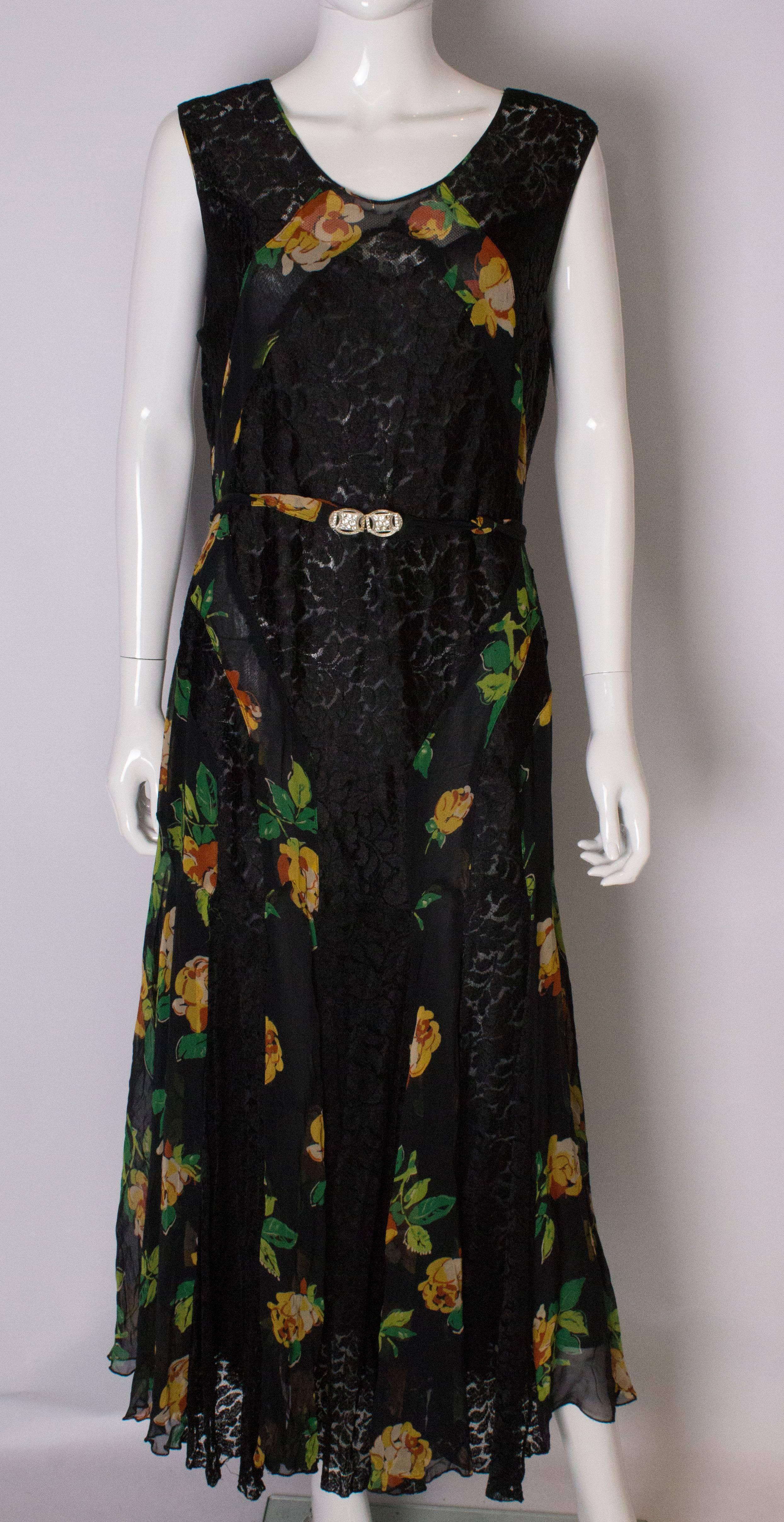 A good 1920s gown in black lace and a floral print. The dress has  v neck and back, and is fully lined There is a marching bolero. and belt.
The dress is meant to be worn loose, and measures: Bust up to 40'', length 56'', bolero bust up to 42'',