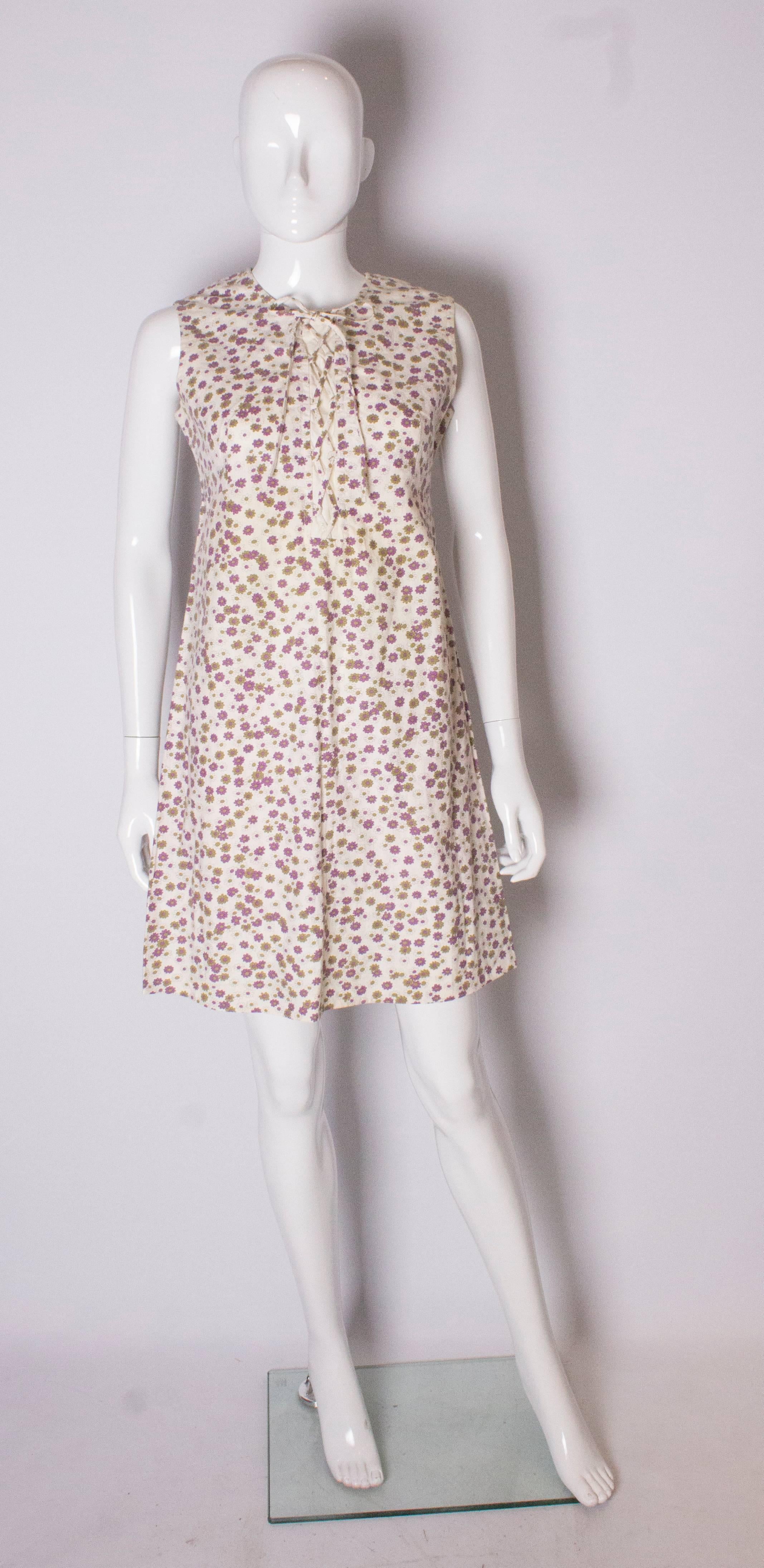 A cute  cotton dress for Summer. The dress is  in a purple, kahki and cream print, and has a lace up front and central back zip.
