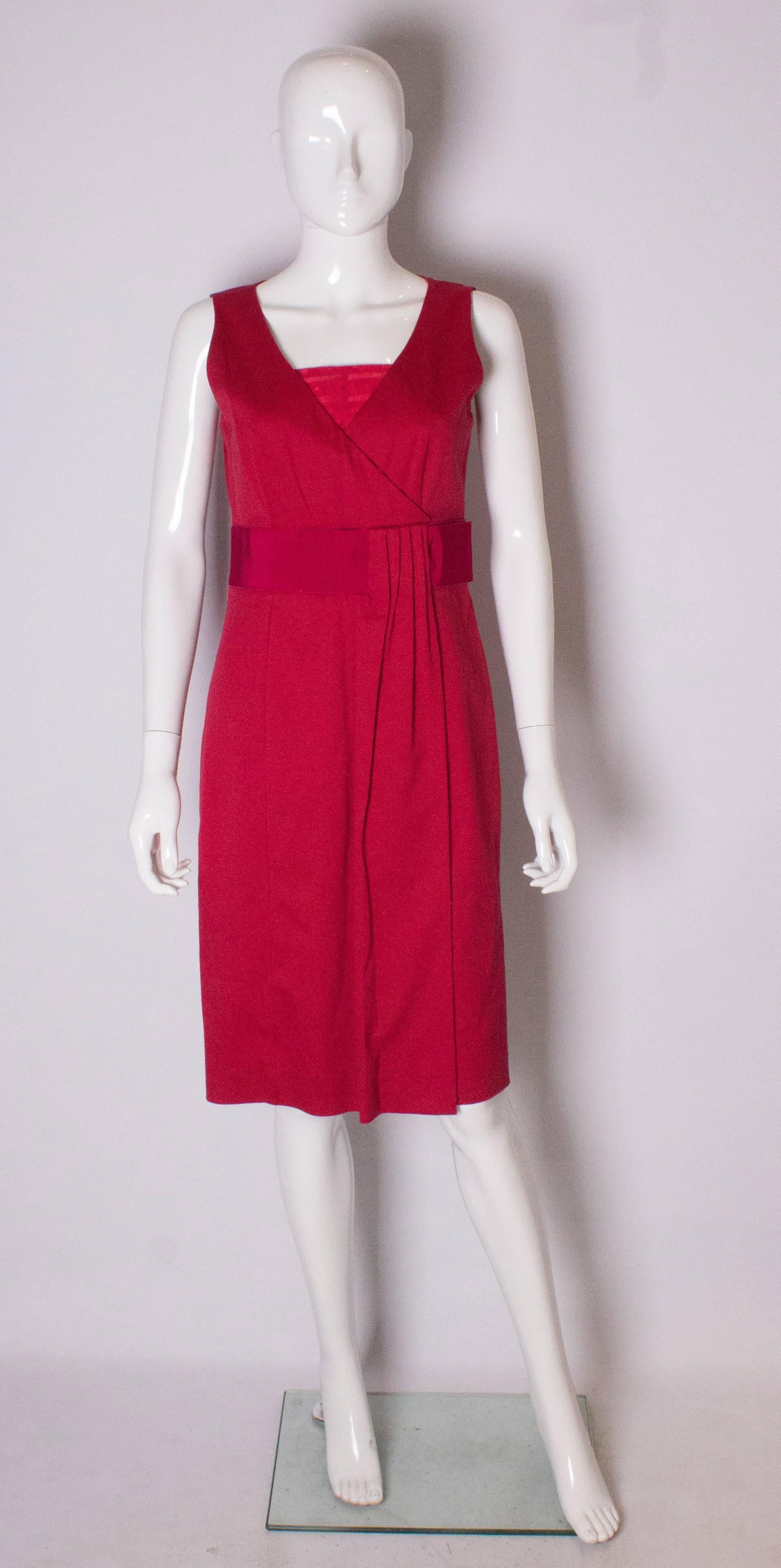 A chic dress by Valentino,Red line. The dress has a v neckline ,a fold over on the front,and  contrating fabric belt.  It has a central back zip, and  6 '' slit at the back.