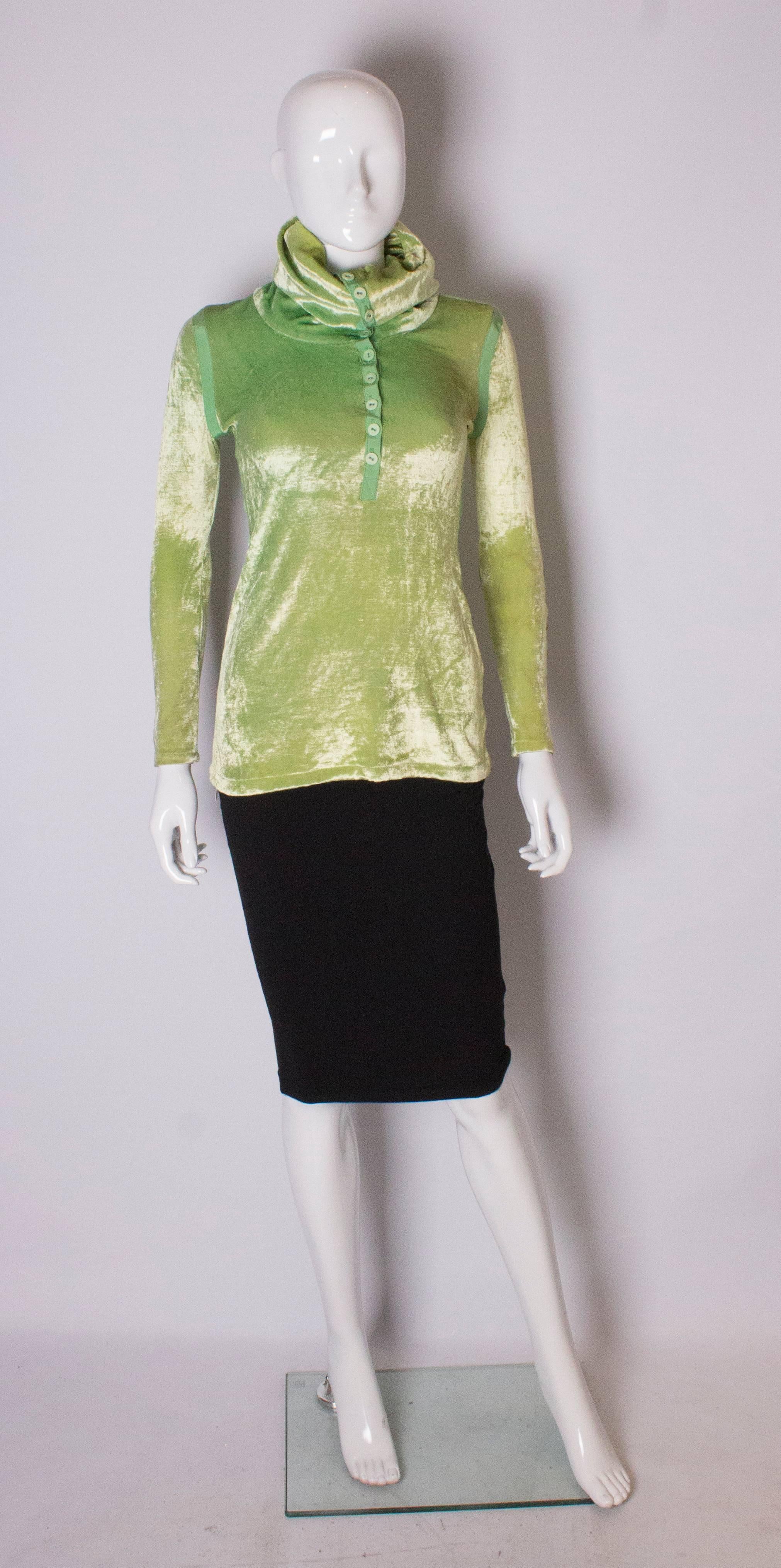  A great top for Spring /Summer.
The top has a rollover neck with button and ribbon detail , and the cuffs also have button  and ribbon detail.