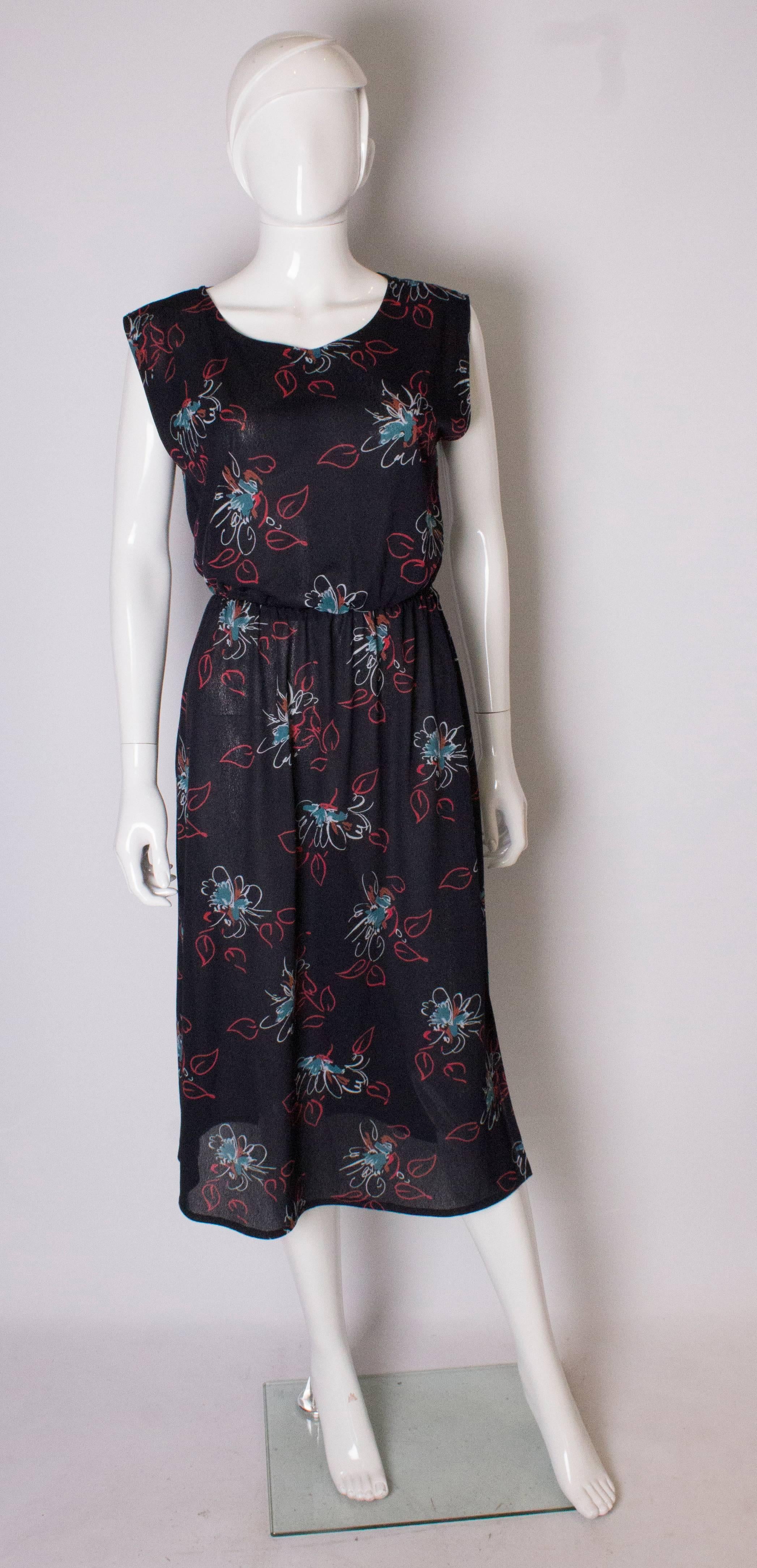 An easy to wear floral printed day dress. The dress is sleavless and  has an elasticated waist , and a 12 ''slit  on the left side.