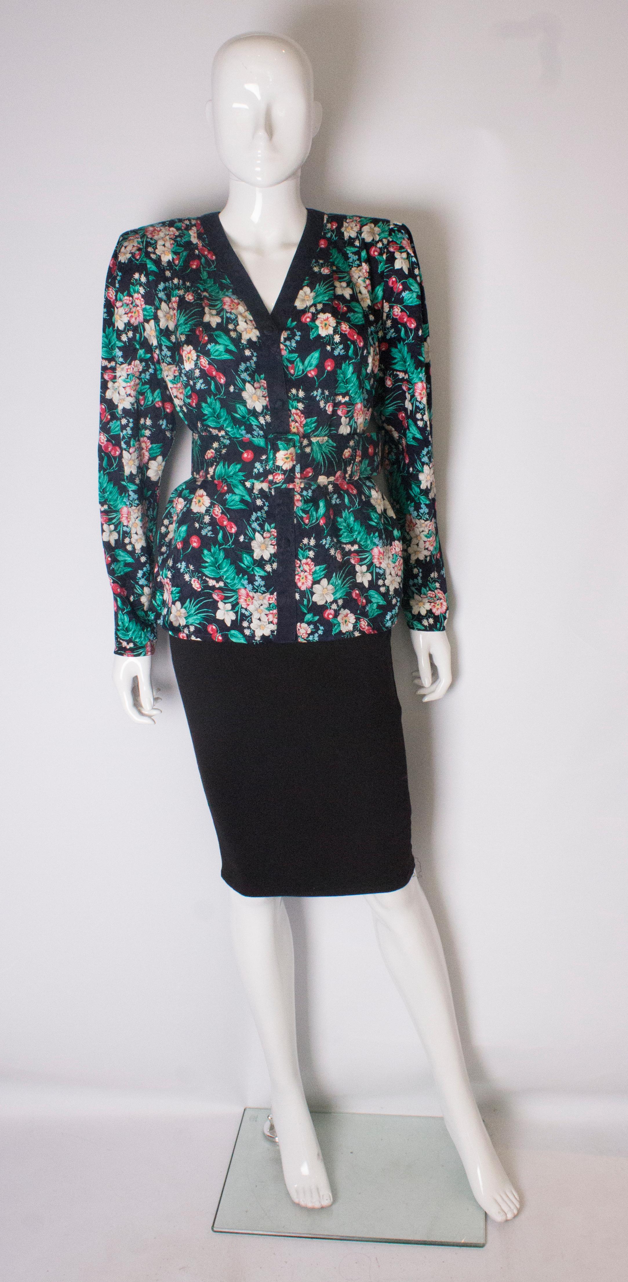 A pretty floral silk jacket by Diane Fres, with matching belt. The jacket has pleats at the shoulder, a v neckline with button fastening. The jacket does have shoulder pads but these can easily be removed.