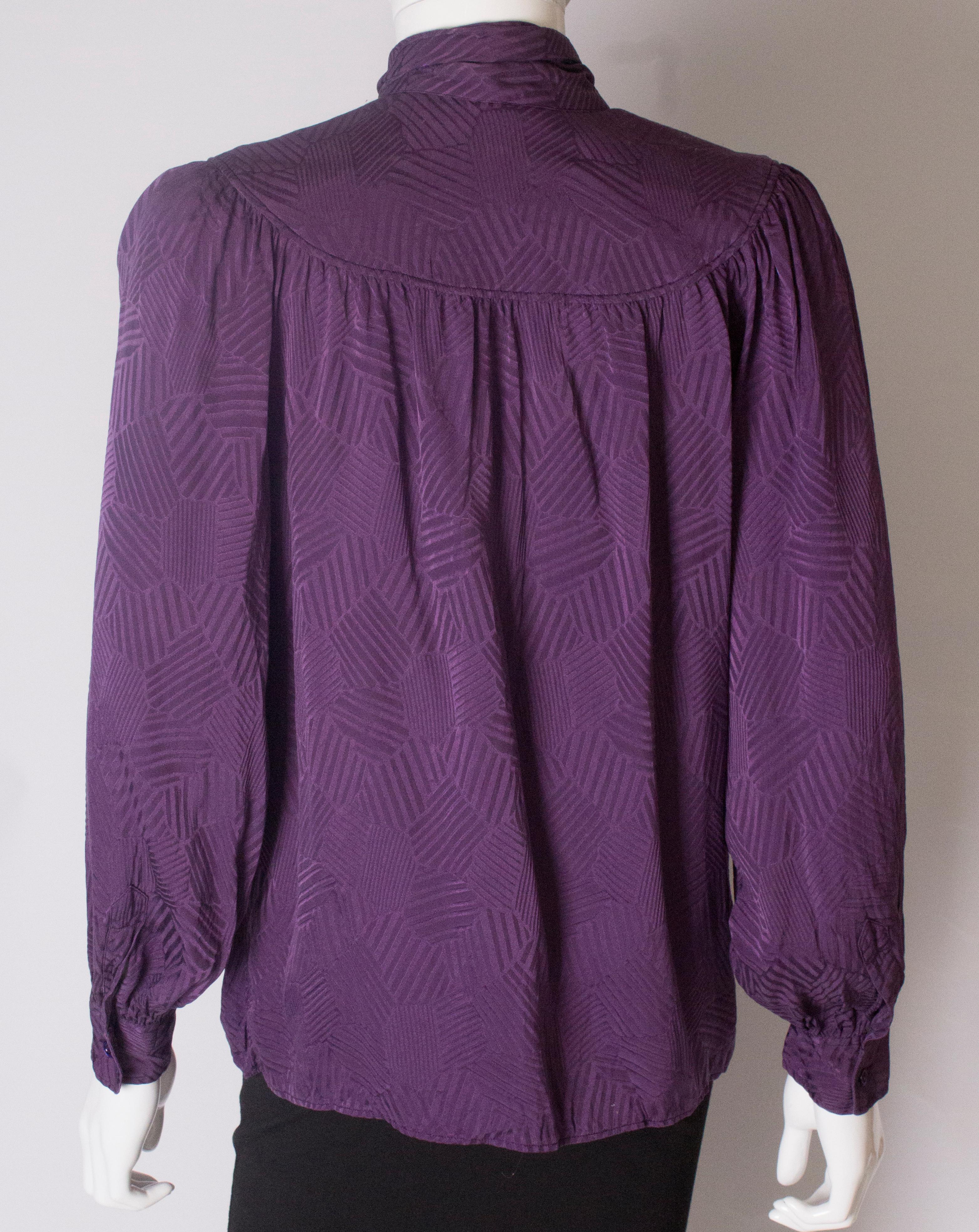 A Vintage 1970s silk purple pussy bow blouse by Yves Saint Laurent  1