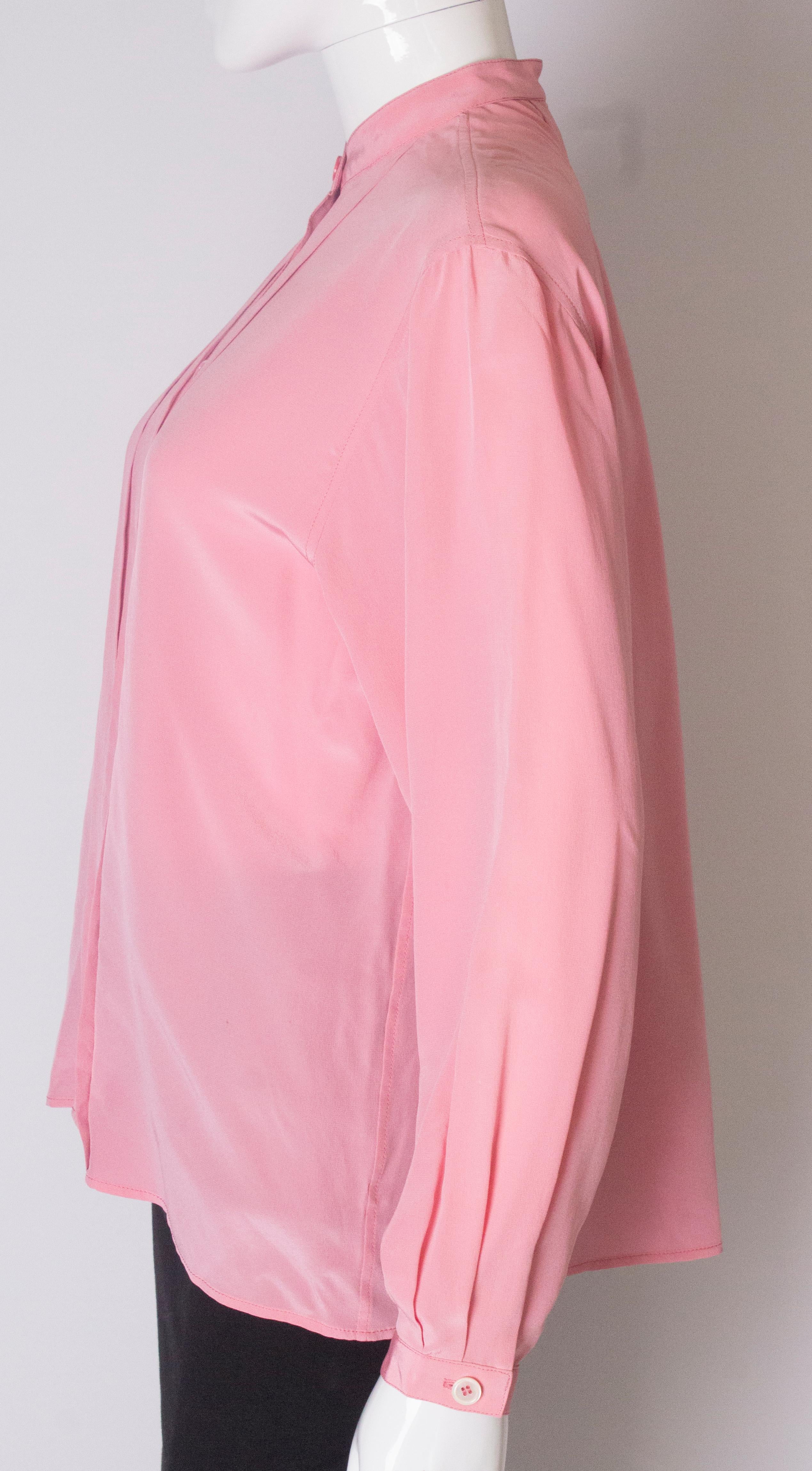 Women's A Vintage 1990s pale pink silk button up blouse by Yves Saint Laurent 