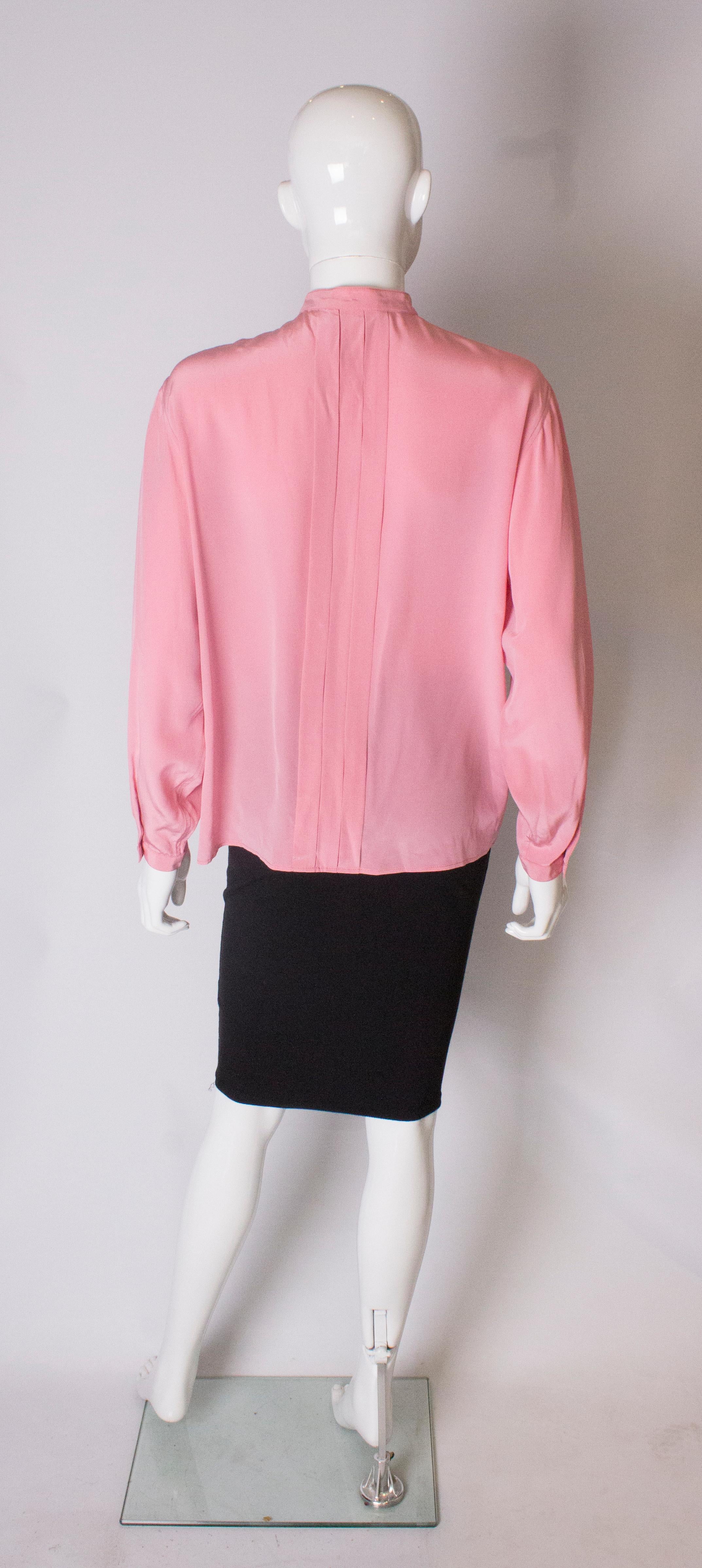 A Vintage 1990s pale pink silk button up blouse by Yves Saint Laurent  1