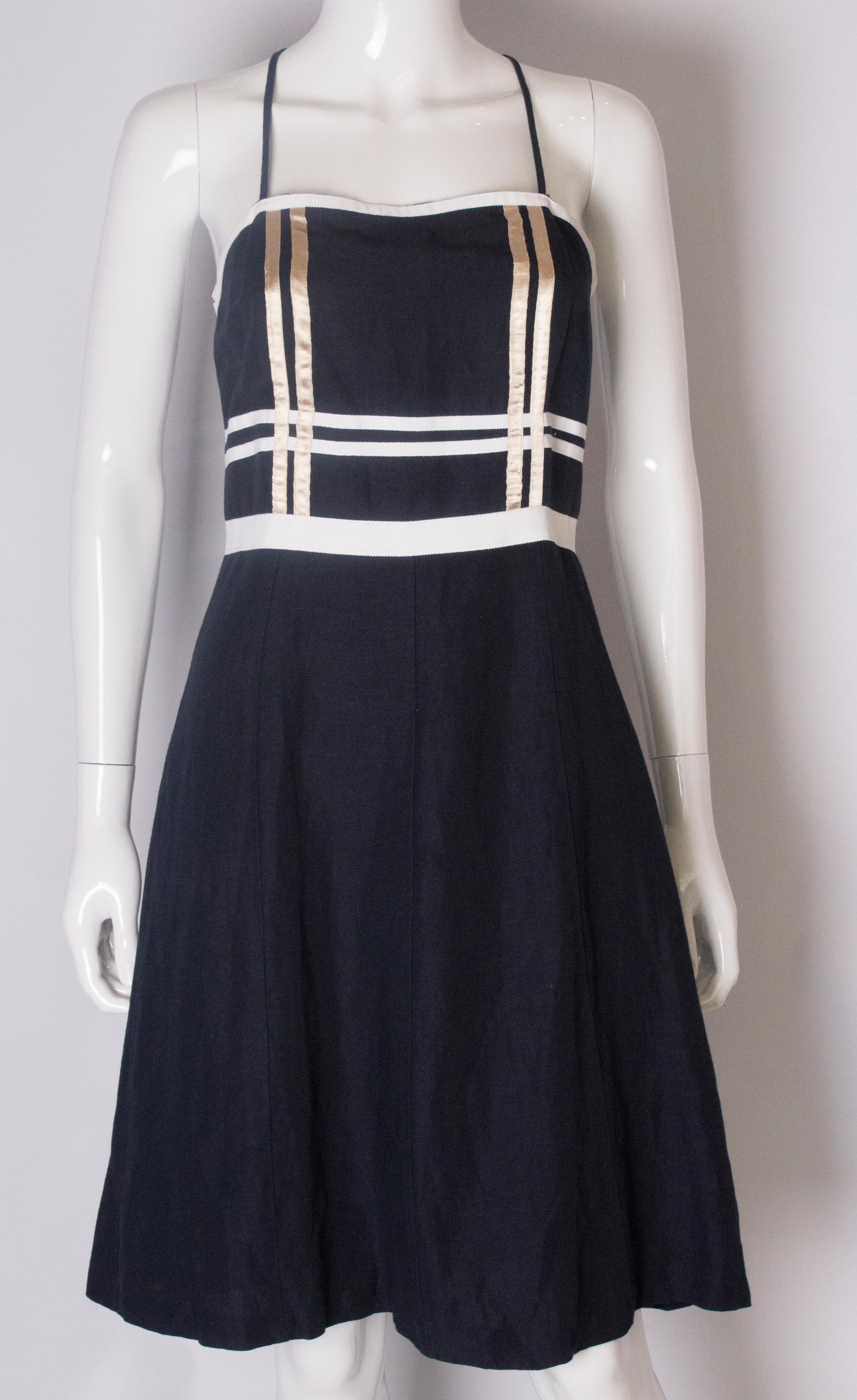 A chic dress by Valentino, main line.    The dress is in a blue cotton with spagetti straps.  The dress has ribbon detail over the bust area.It is fully lined , with a central back zip.