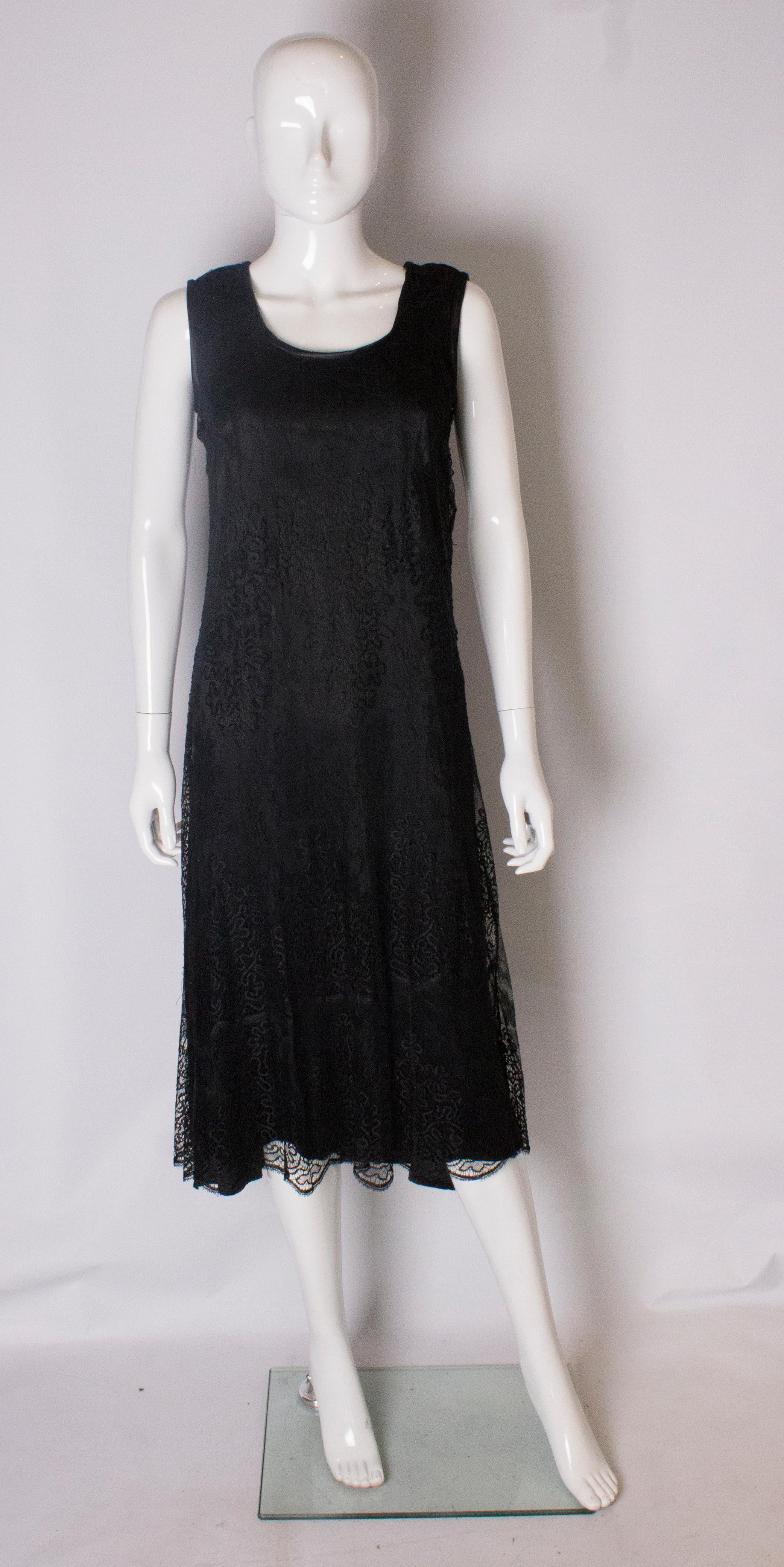 A pretty black lace dress from the 1920s.  The lace has a very pretty design and has poppers on the shoulder as an opening and is fully lined.