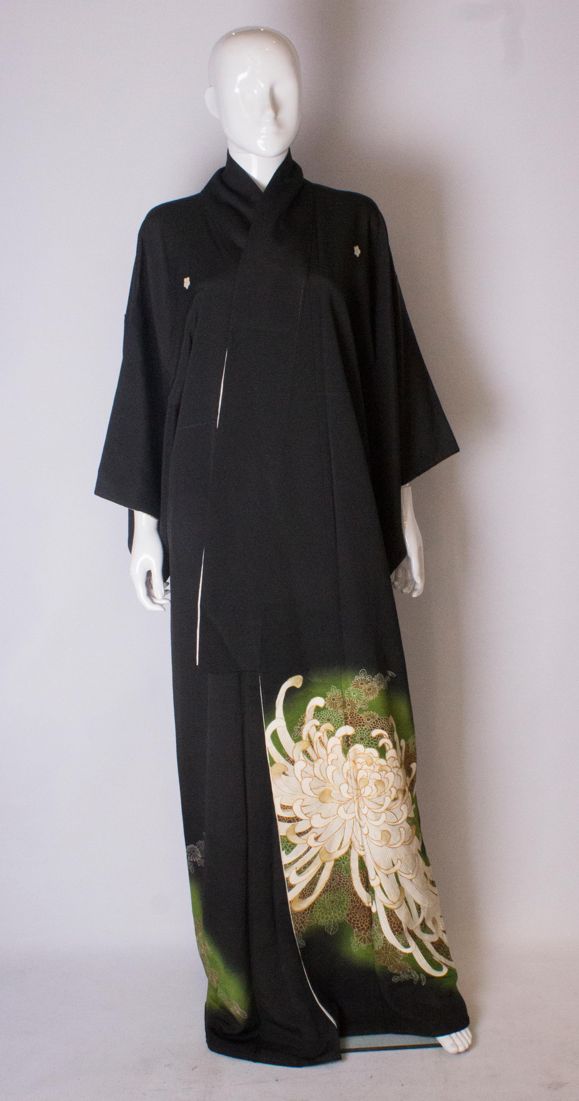 A chic black kimono with stunning detail on the lower area. The black kimono is lined in silk, and has wonderful embroidered detail near the hem. Measurements; bust up to 44'', length 164''.