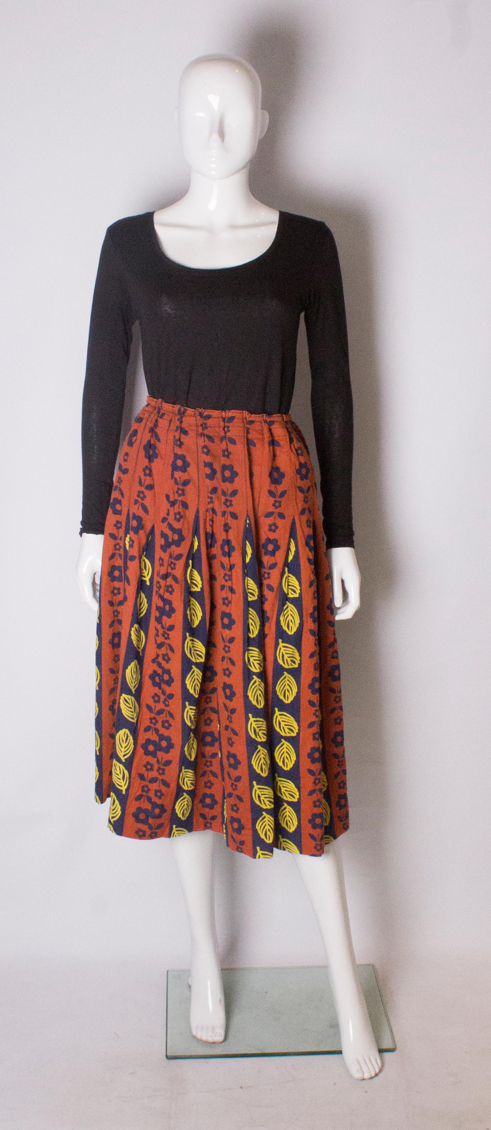 A lovely skirt for Autumn/Fall The skirt is made of a heavy cotton, with a rust colour background and blue and yellow design. It has an elasticated waist, and so can fit a waist from 28'' to 38'''.