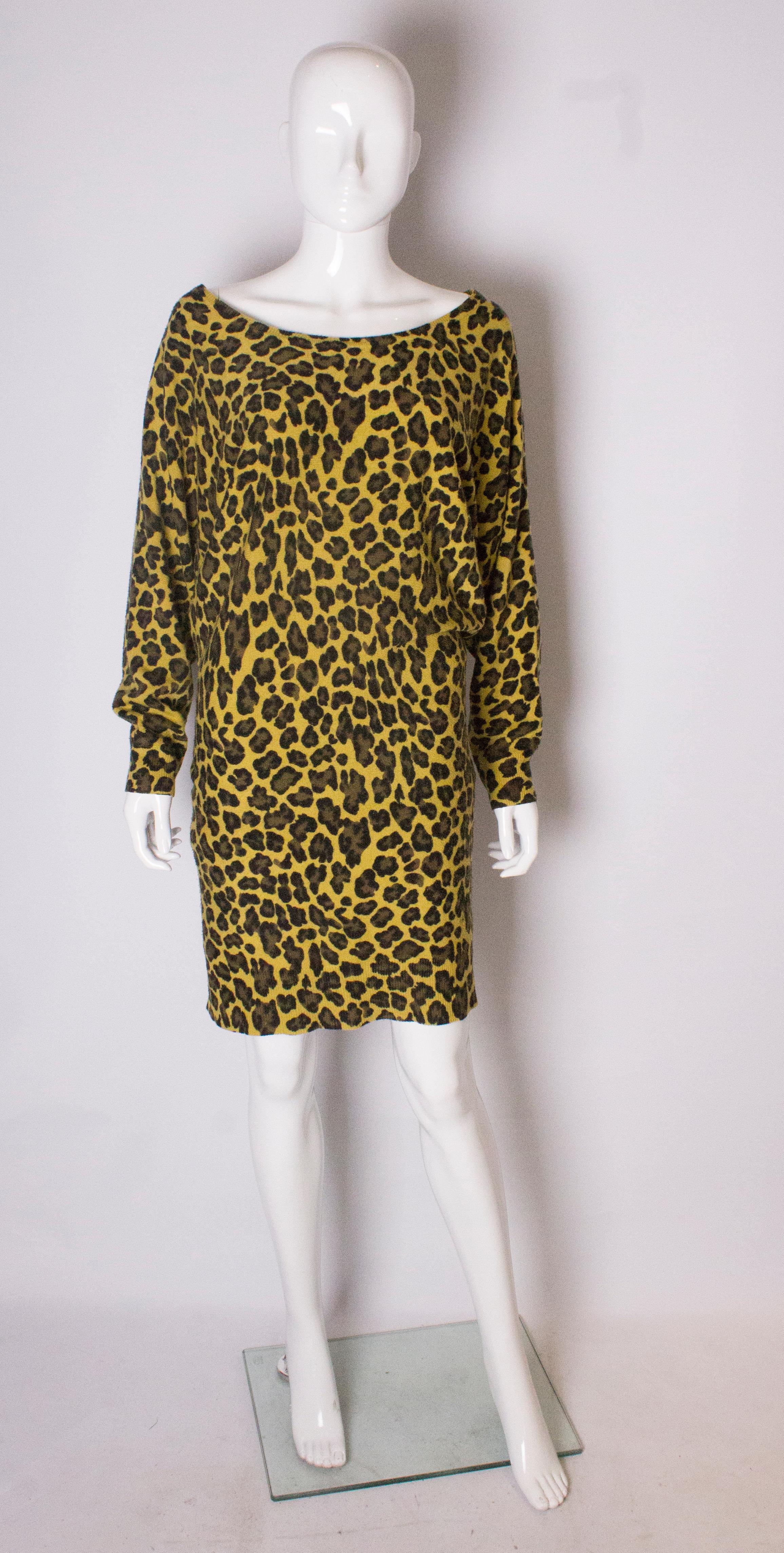 A great dress for Fall by Us designer Betsey Johnson.The sweater dress has a round neckline,and is in a mustard yellow background with an olive and brown animal print design. The sweaterdress has ribbed edges and batwing sleaves.