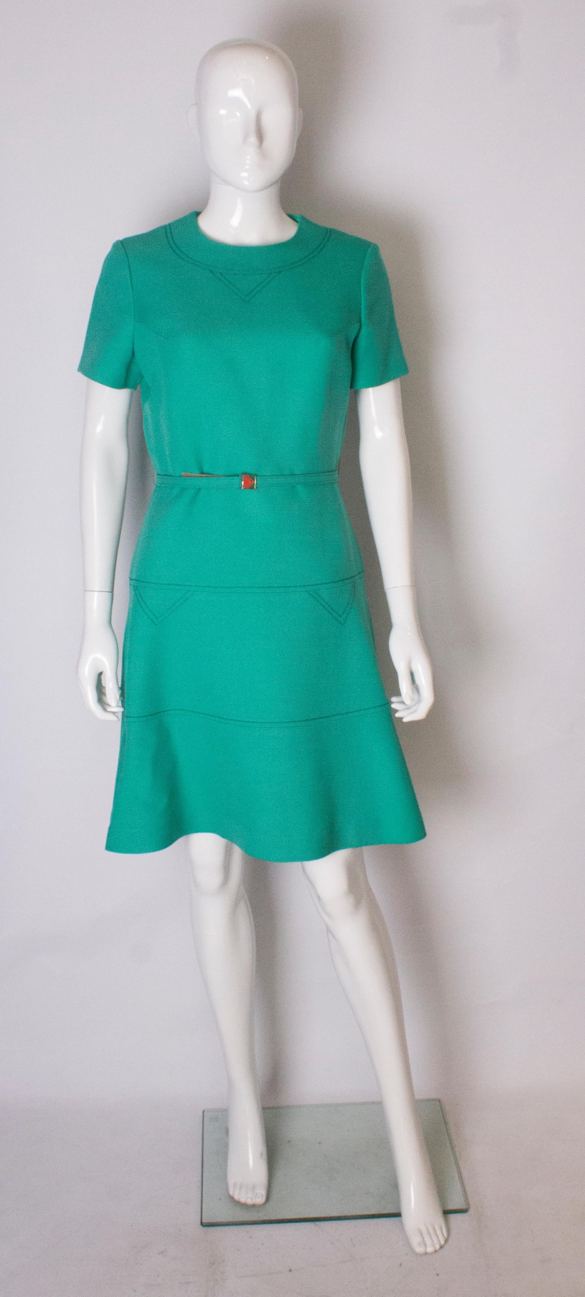 A stunning dress by Louis Feraud for Rembrant. The dress is in a vibrant  green and has stitch detail on the shoulder and skirt area. It is fully lined  has  a central back zip, and self fabric belt.
