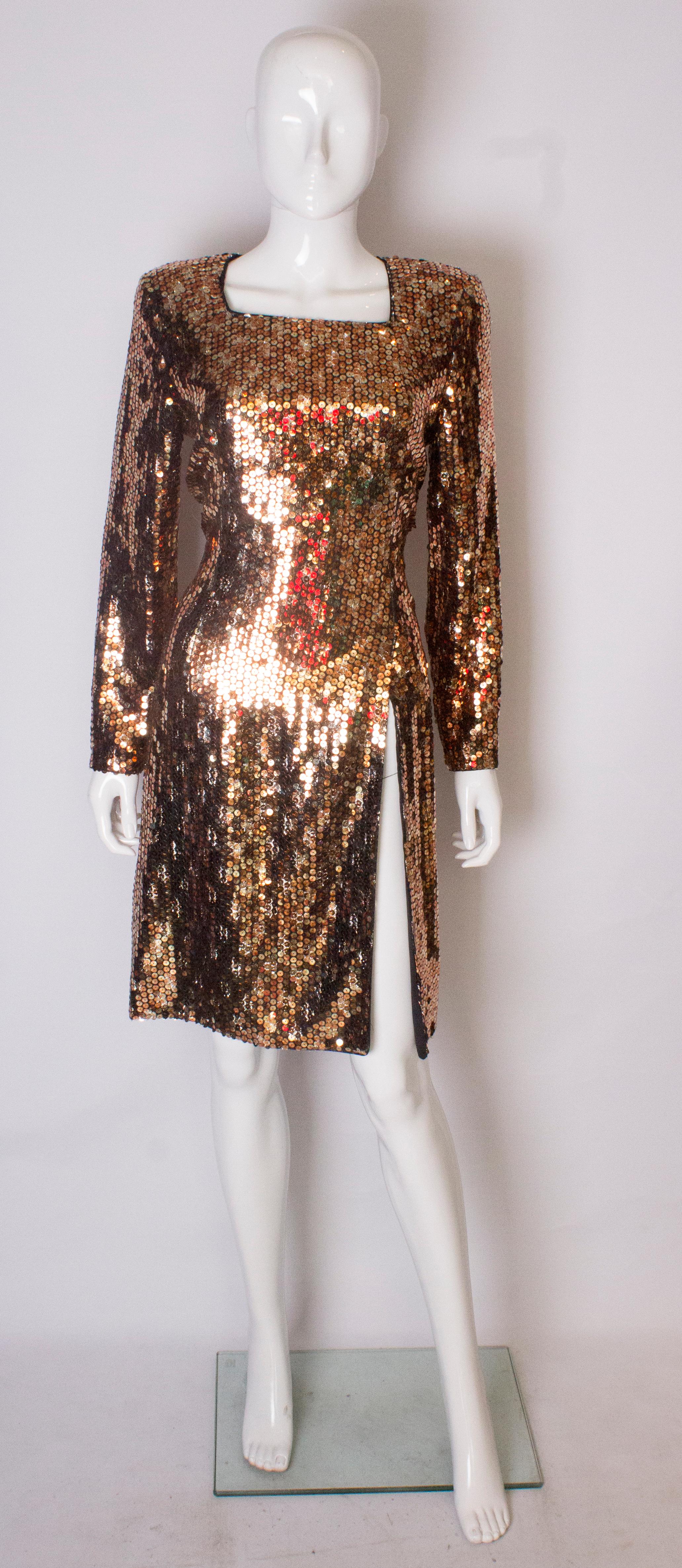 A headturning party dress  by Mani. The dress is in a wonderful mix of copper colour sequins backed with pieces of net. It has a square neckline, and a central back zip, There is a 20'' slit at the front ( good for dancing) and the dress is fully