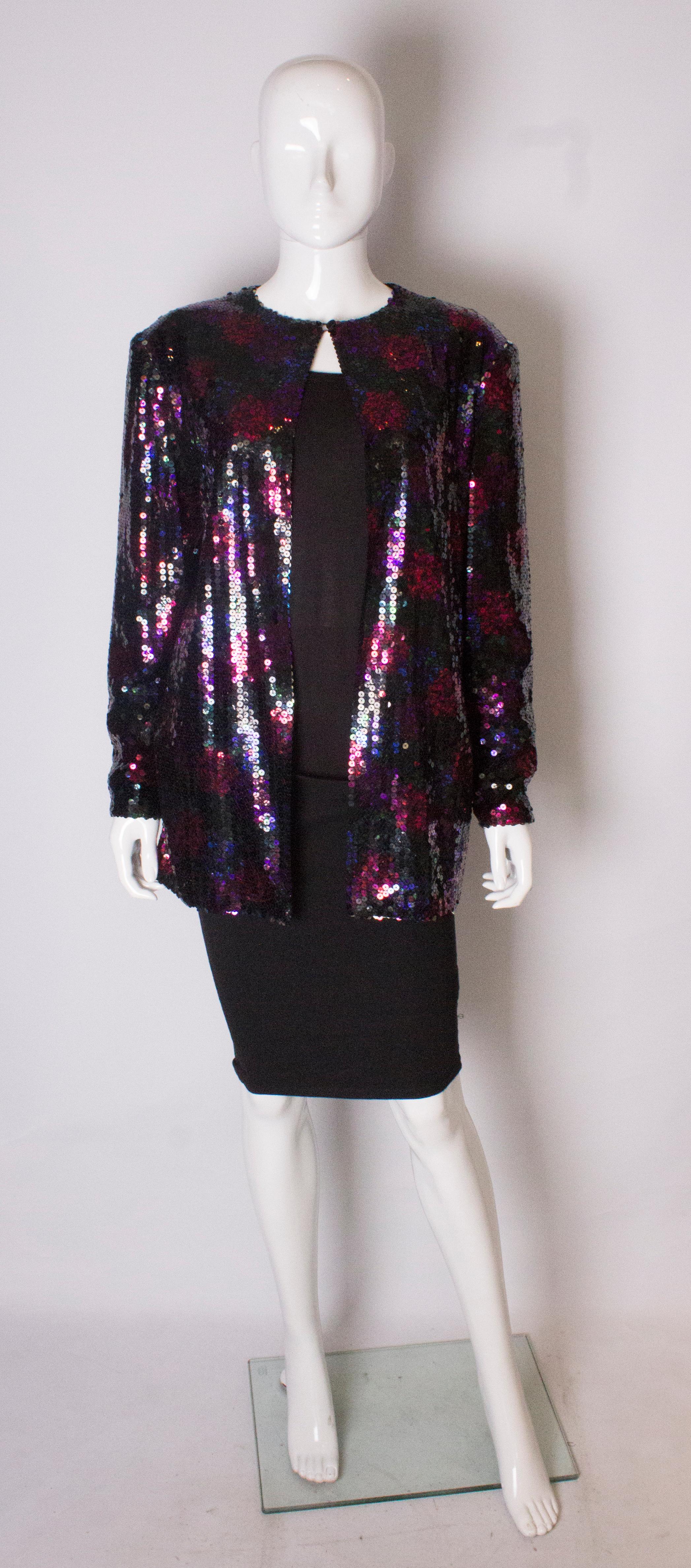 A chic and easy to wear jacket by Jacques Azagury. The round neck jacket fastens with one button at the neck and is in a combination of pink, red and purple sequins. It fits a bust up to 40''.