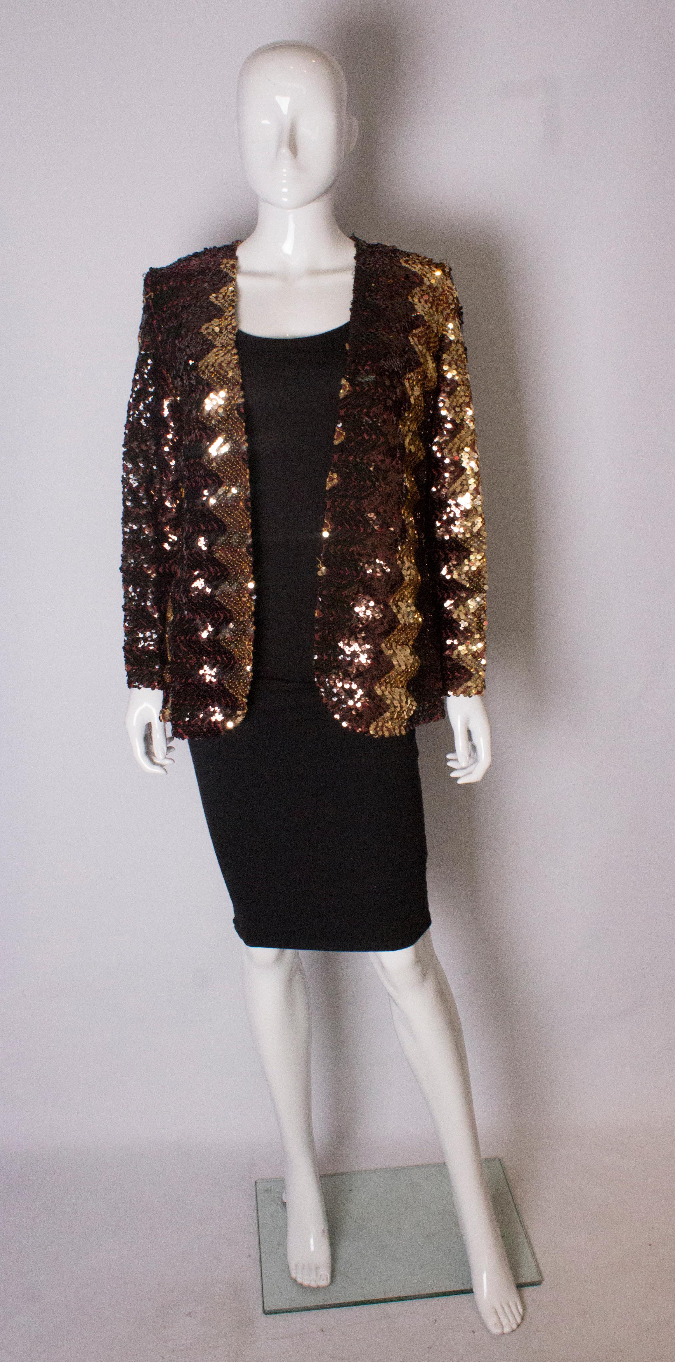 A chic sequin jacket by Sportaville UK.The jacket is decorated in copper, bronze and brown sequins in an unusual vertical design. The jacket has a v neckline.