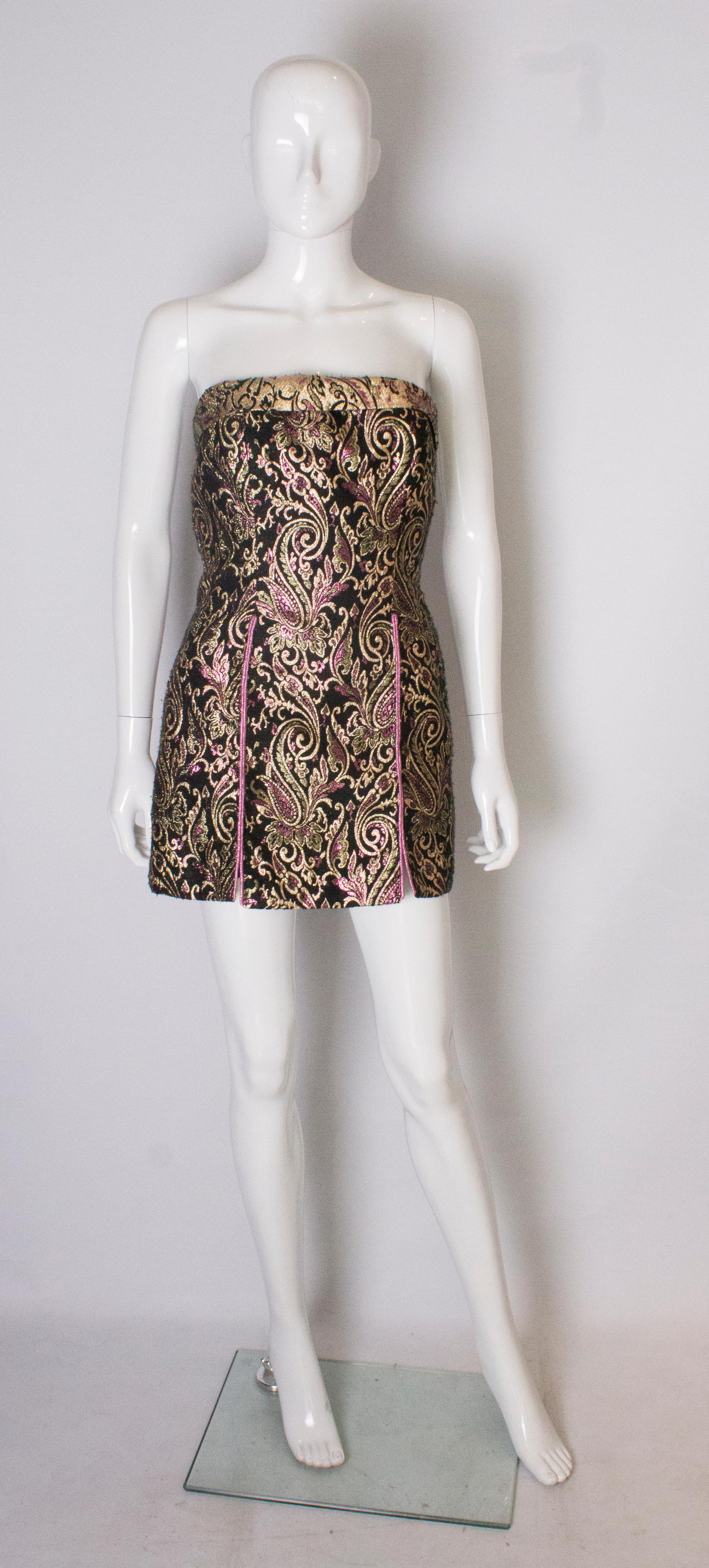 A stunning vintage top /mini dress.  The dress is sleeveless with a roll over top, central back zip and is fully lined. 