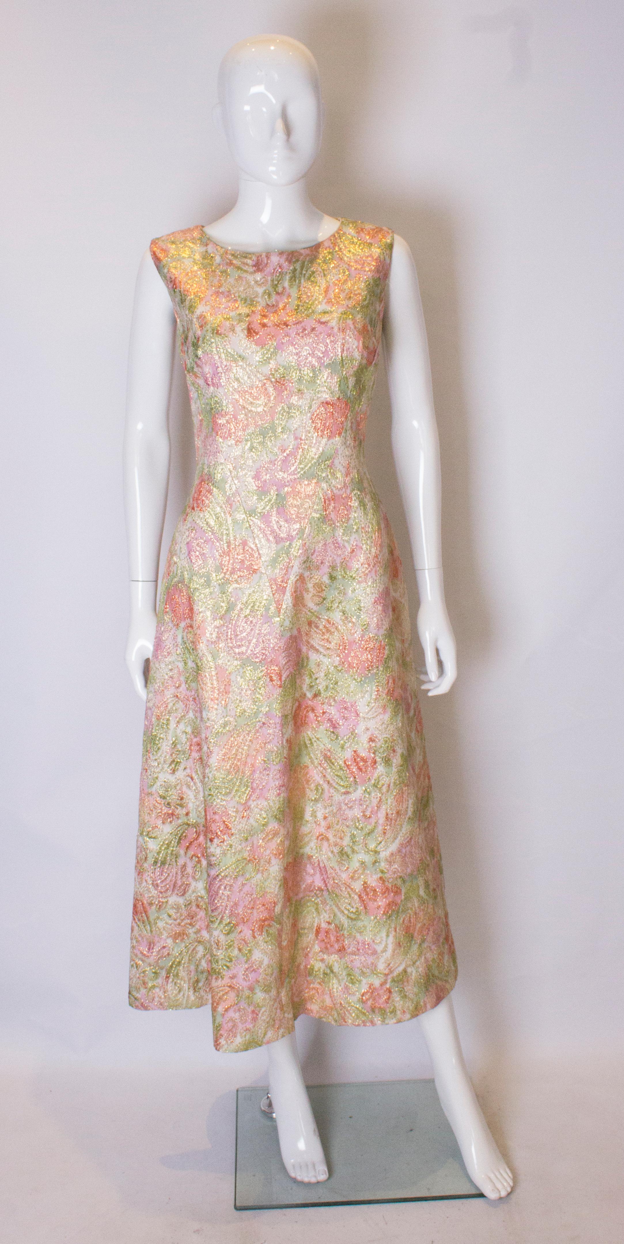 A pretty gown by Global Style in Paris. The gown is in a pretty pink and green colour, is sleeveless, and is fully lined with a central back zip.
