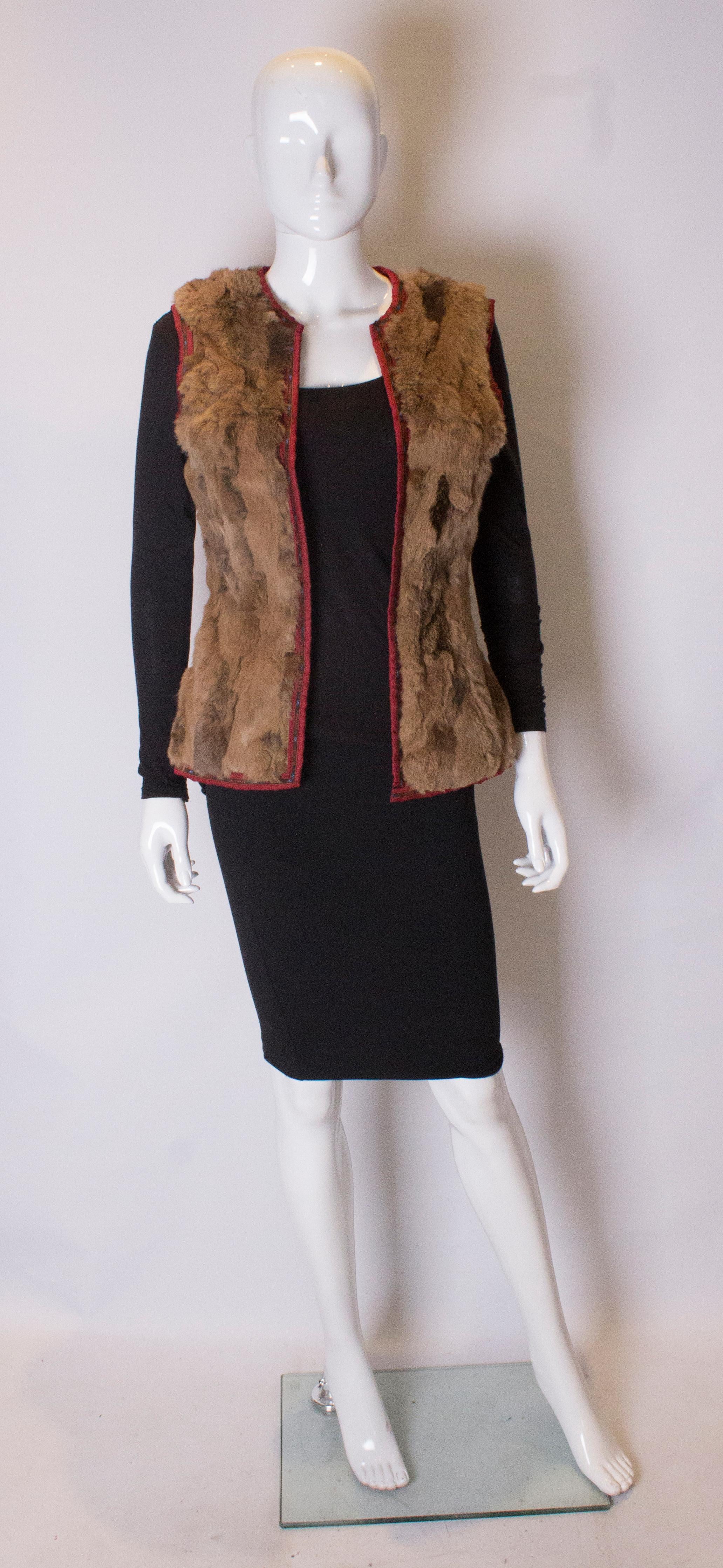 A chic and warm rabbit fur gilet by Etro. The gilet is lined in brown fabric and edged with Etro banding.