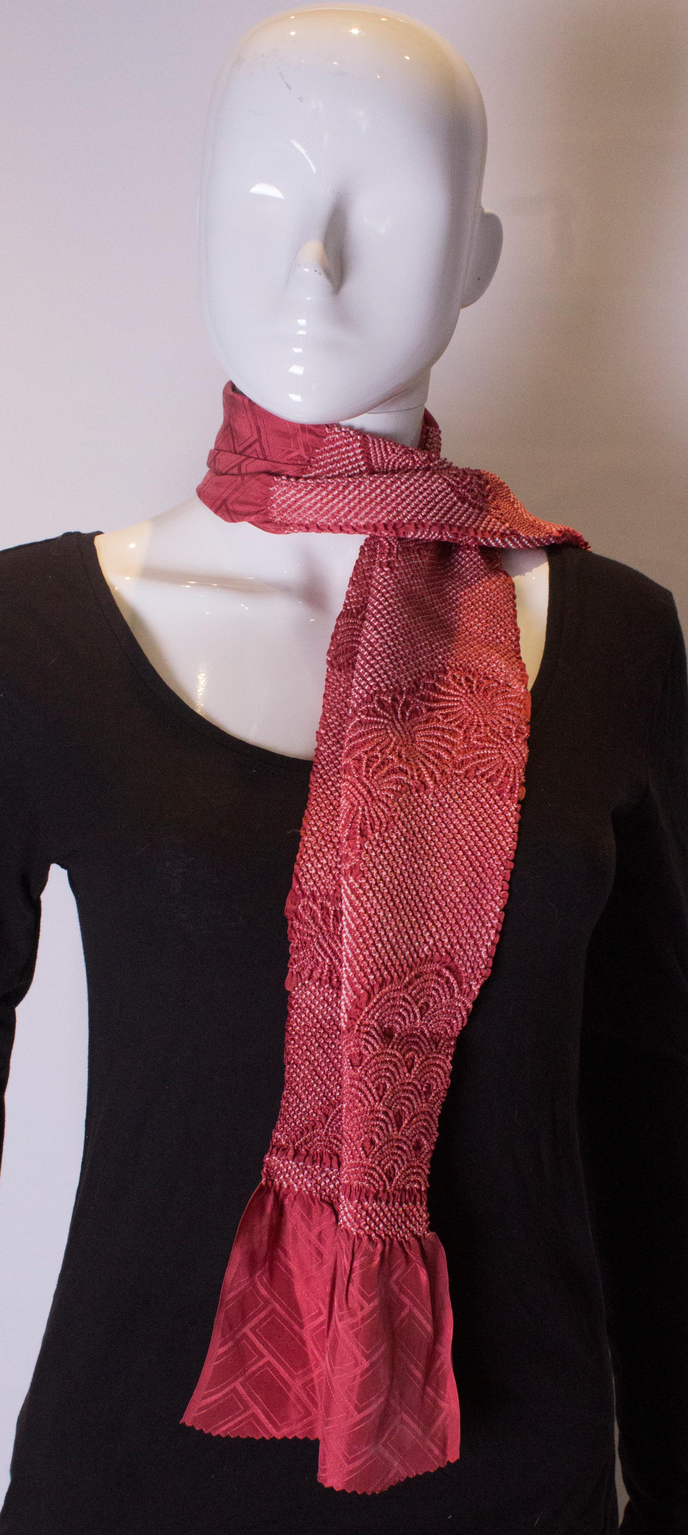 A lovely deep rose pink silk scarf with Shibori detail. Length 53'', width 9 1/2''.