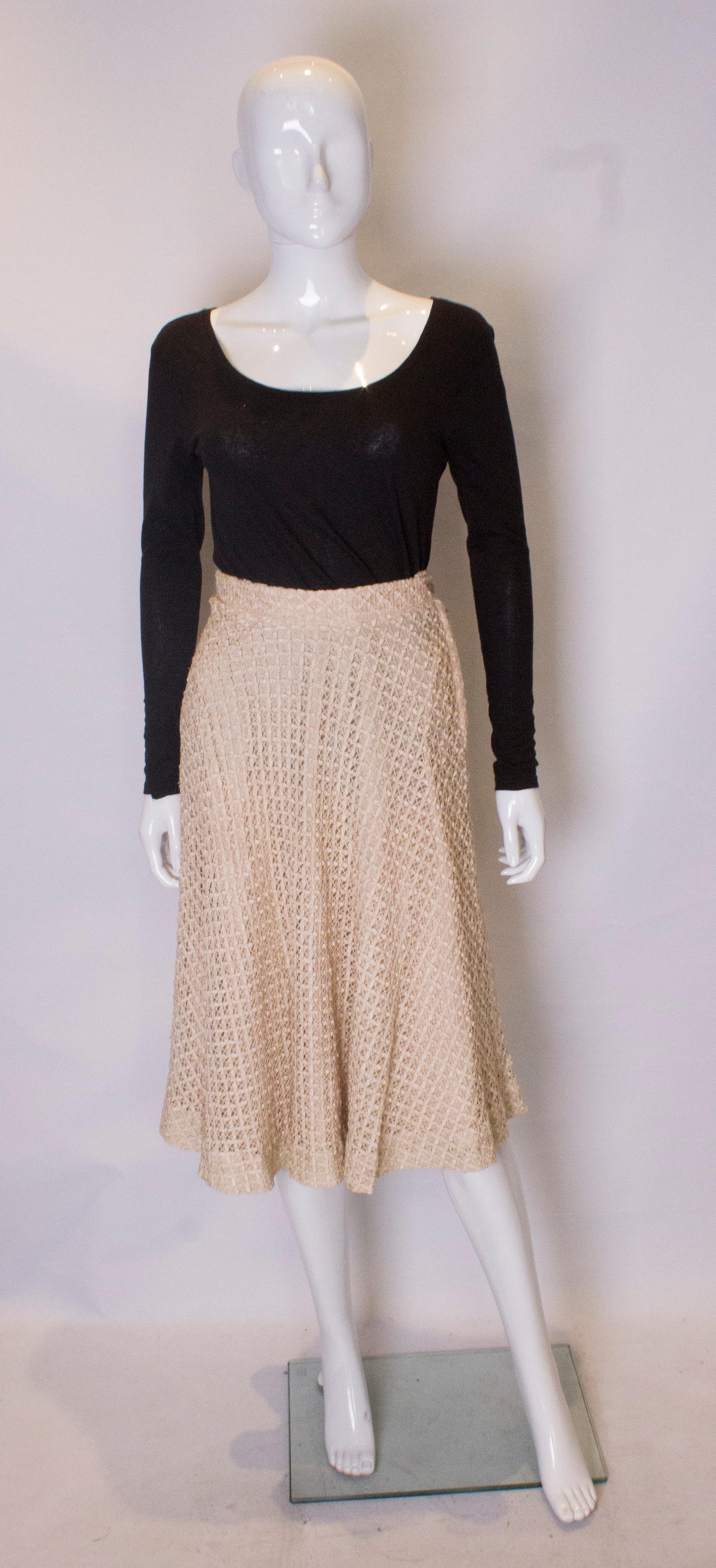 A vintage 1950s cream ribbon woven swing skirt 

Sits on the waist and fastens with zip and a button

measurements taken flat in inches  

waist 12.5
length - 29

