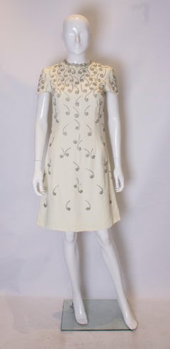 A vintage 1960s cream silver beaded music note A line shift party dress