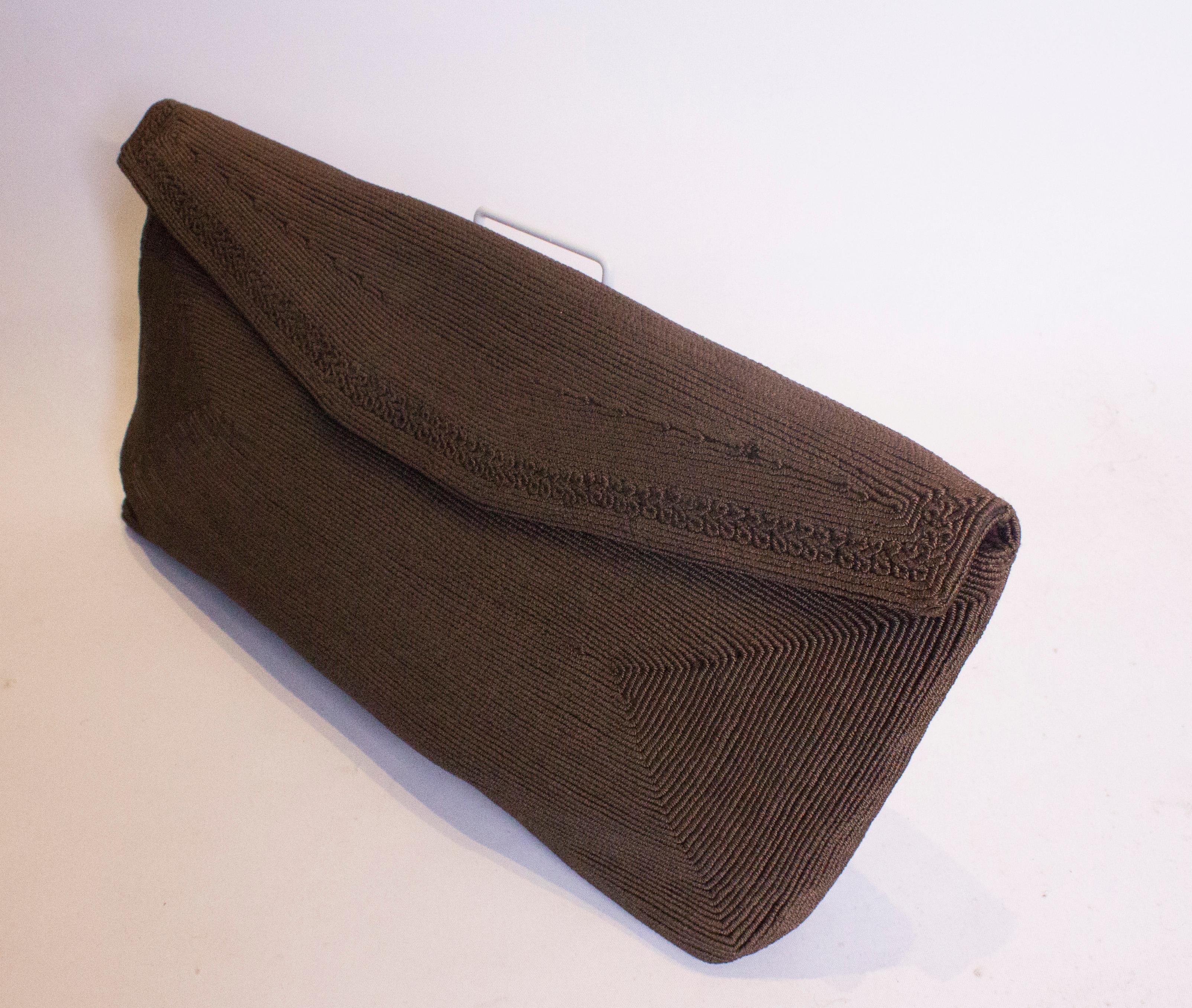 A chic vintage clutch handbag by Corde.This large brown envelope bag has a flap over front with a poper fastening and one internal pouch pocket.  Measurements: Width 15'', height 7'' depth 2''