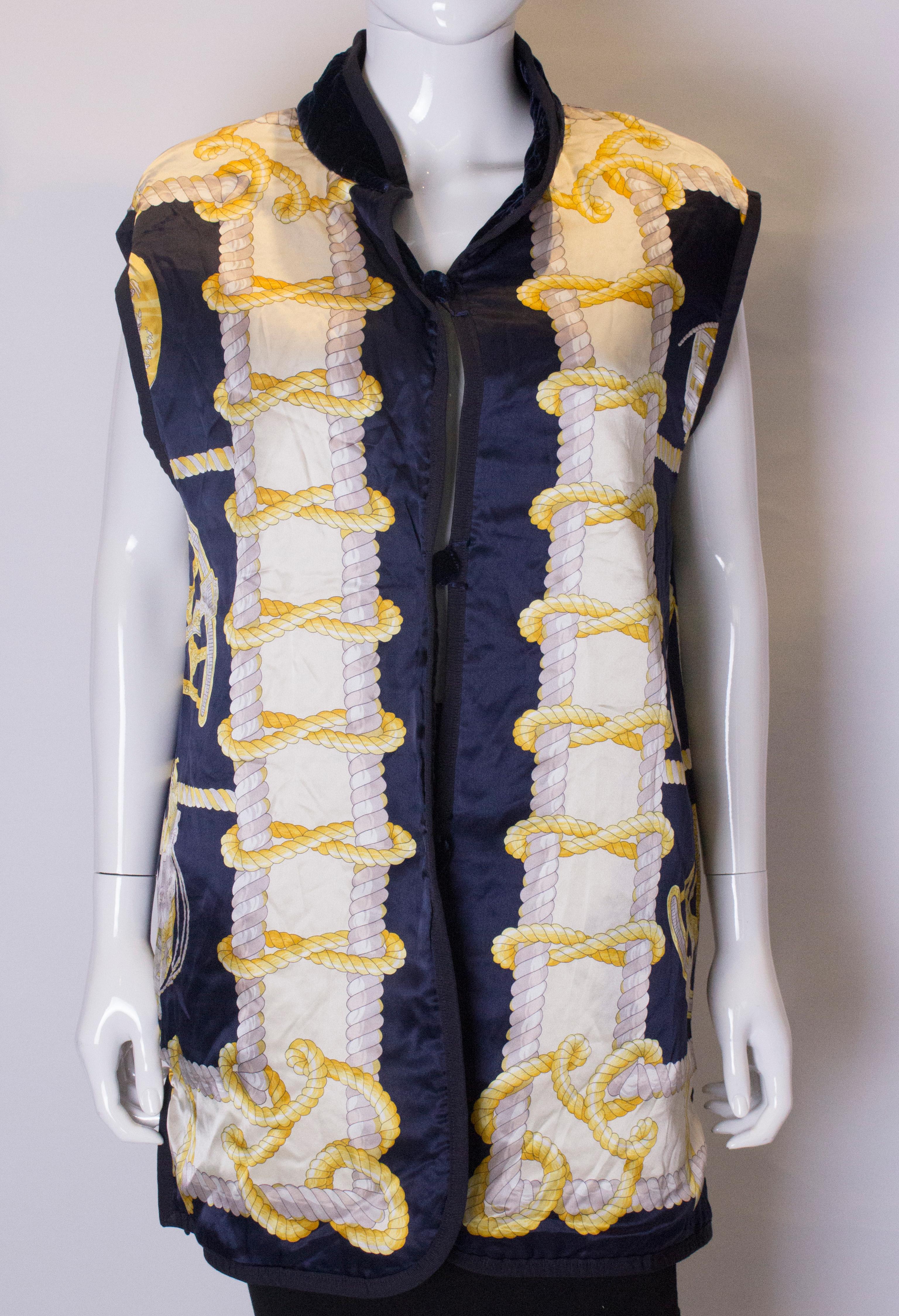 A great items for Fall  or Winter. This reversible gilet, is blue quilted velvet on one side , with two pockets . The others side is silk  , in a nautical print.  It has a stand up collar and 4 '' slits on either side. Measurements bust up to 44',