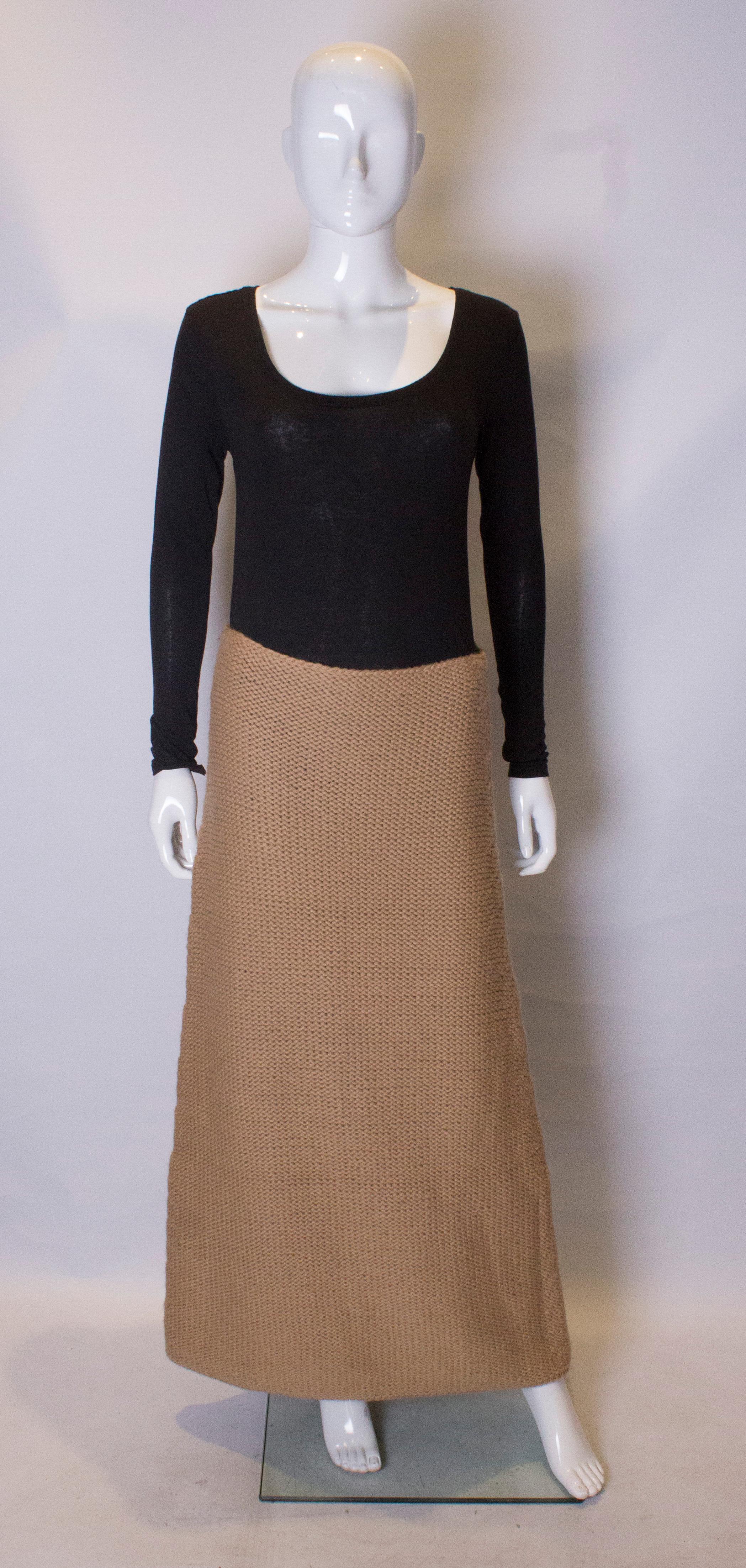 A cut caramel colour knitted skirt by Alberta Ferreti.  The skirt is a line, with a side zip opening, and is knitted in a heavy wool.