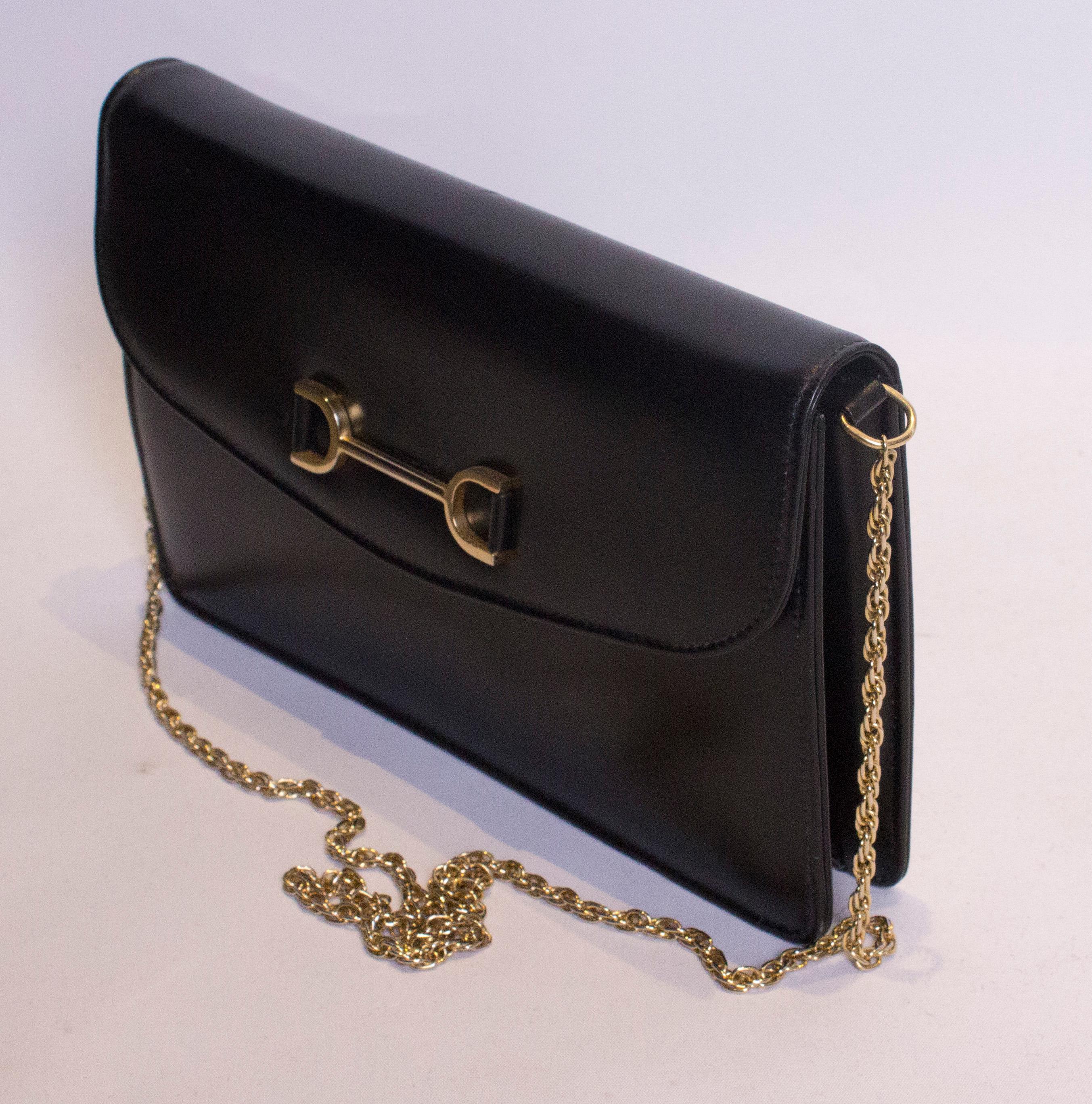 A chic bag by Launer, handbag maker to the Queen.  This bag can be worn as a clutch bag or hand bag with the gold chain fitting inside if not required. Inside there is one internal zip pocket and one pouch pocket. It has a fold over front and popper