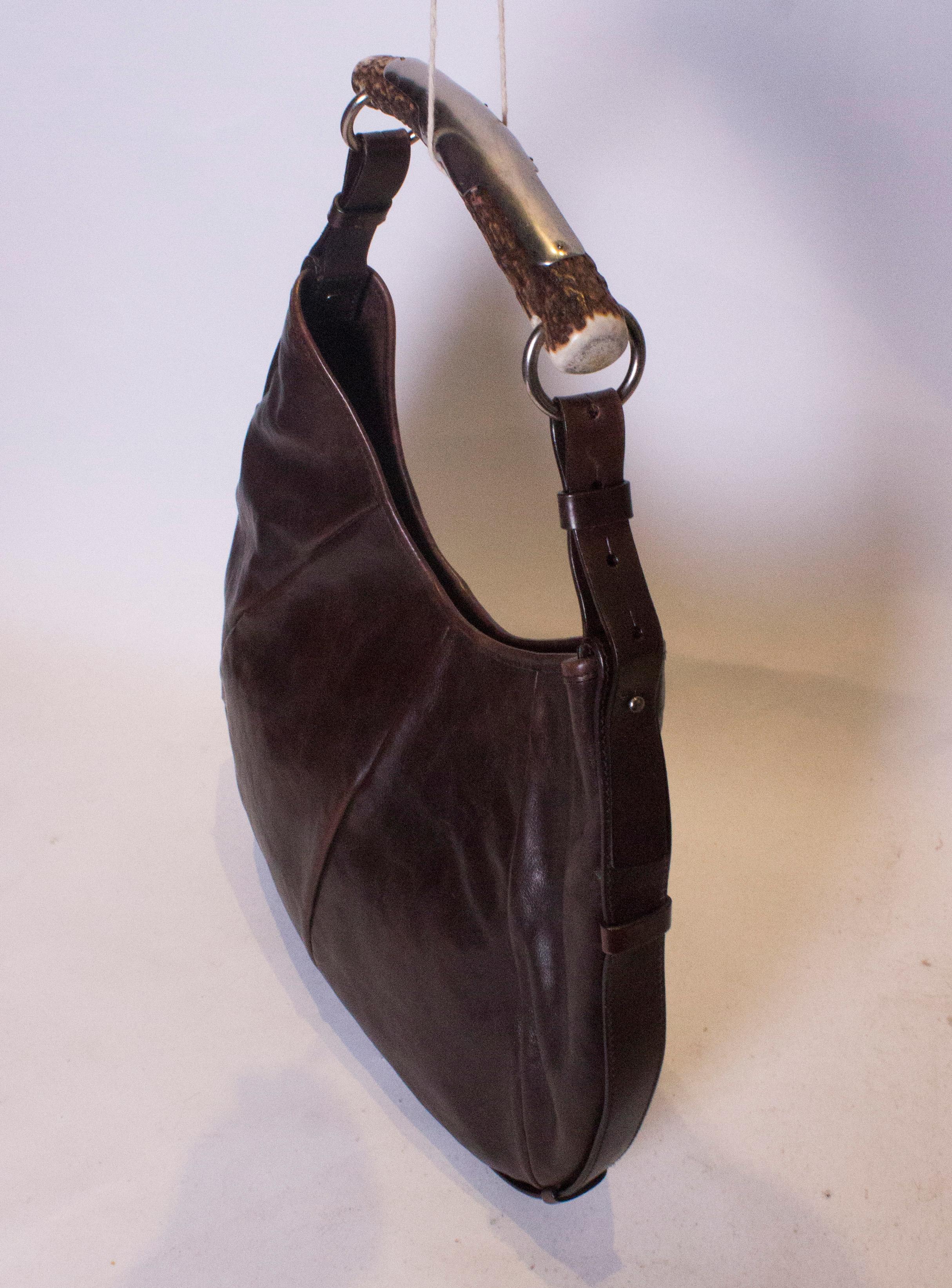 A chic YSL chestnut  brown leather mobassa hobo bag , with a horn handle and adjsutable strap The bag has a popper fastening and internal zip pocket. Measurements width 16'', height 12''  depth 1''