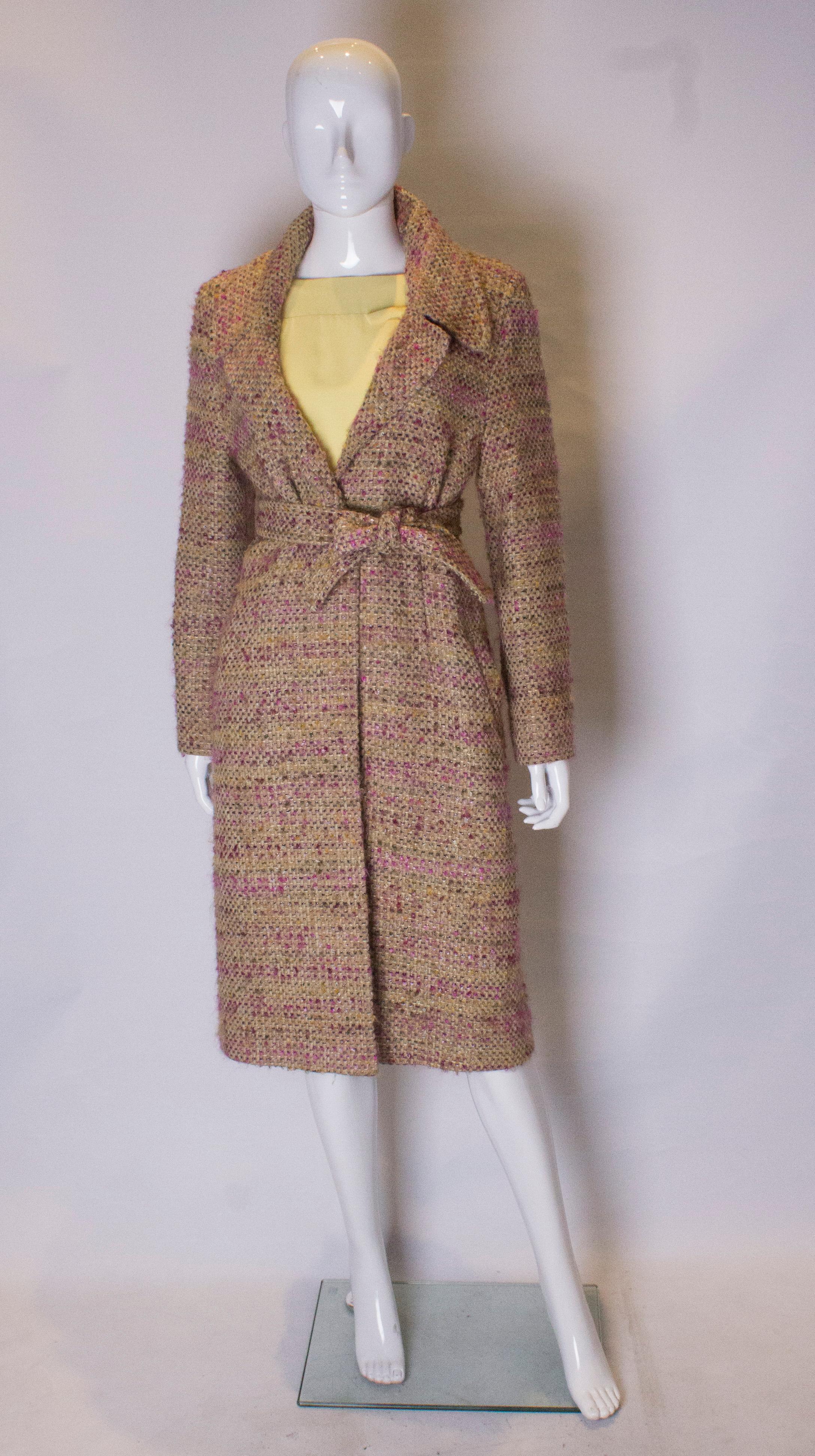 A great  dress for Fall from Jean Muir. The  coat is in a wool mix in pretty shades of violet , green and ivory . It is fully lined and has a one button fastening , two pocket and a self fabric tie belt.