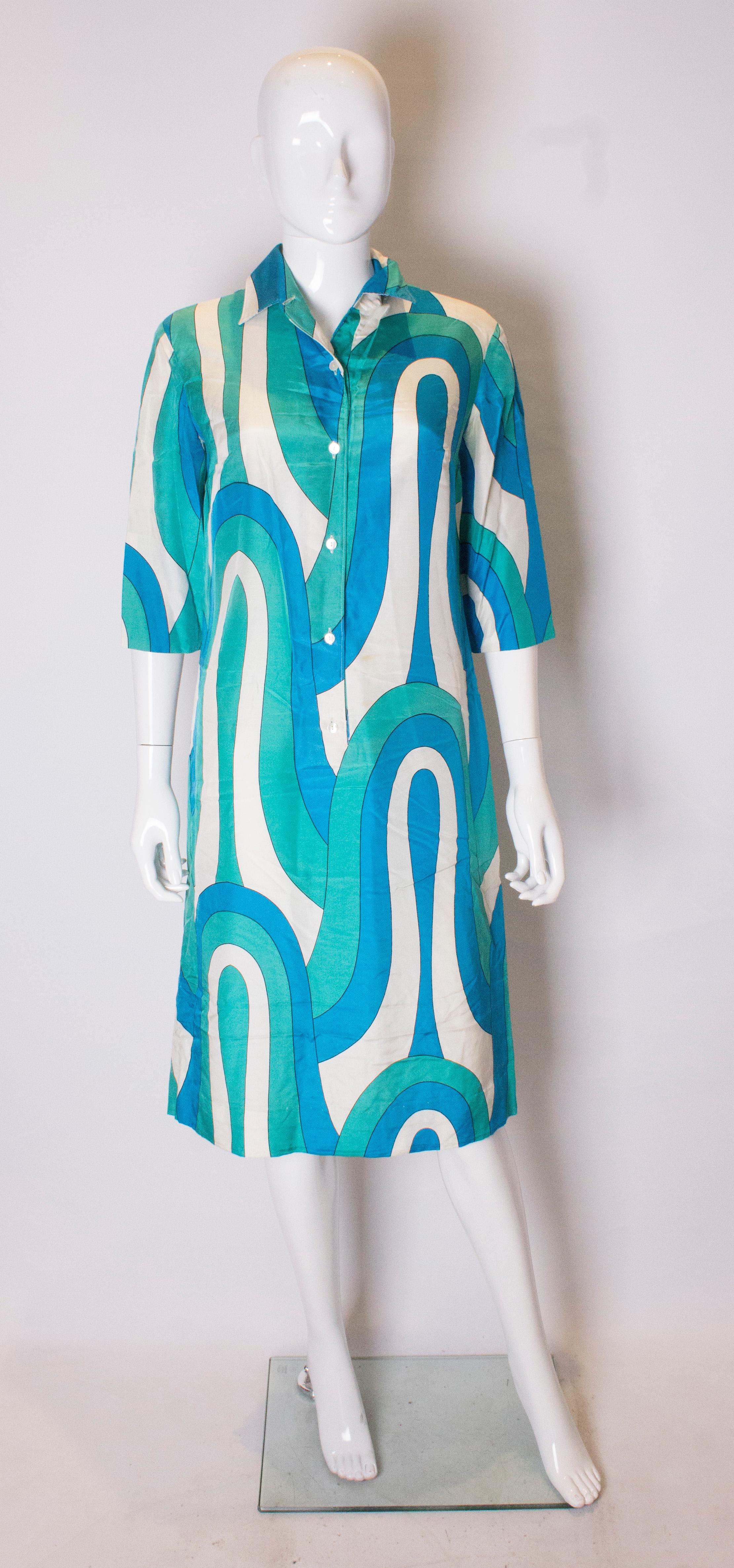 A great pucciesque Italian silk shirt dress from Harrods The dress is in a wonderful silk in shades of blue , green and white. It has a six button front opening, and elbow length sleaves.   It has a  2 1/2'' hem.