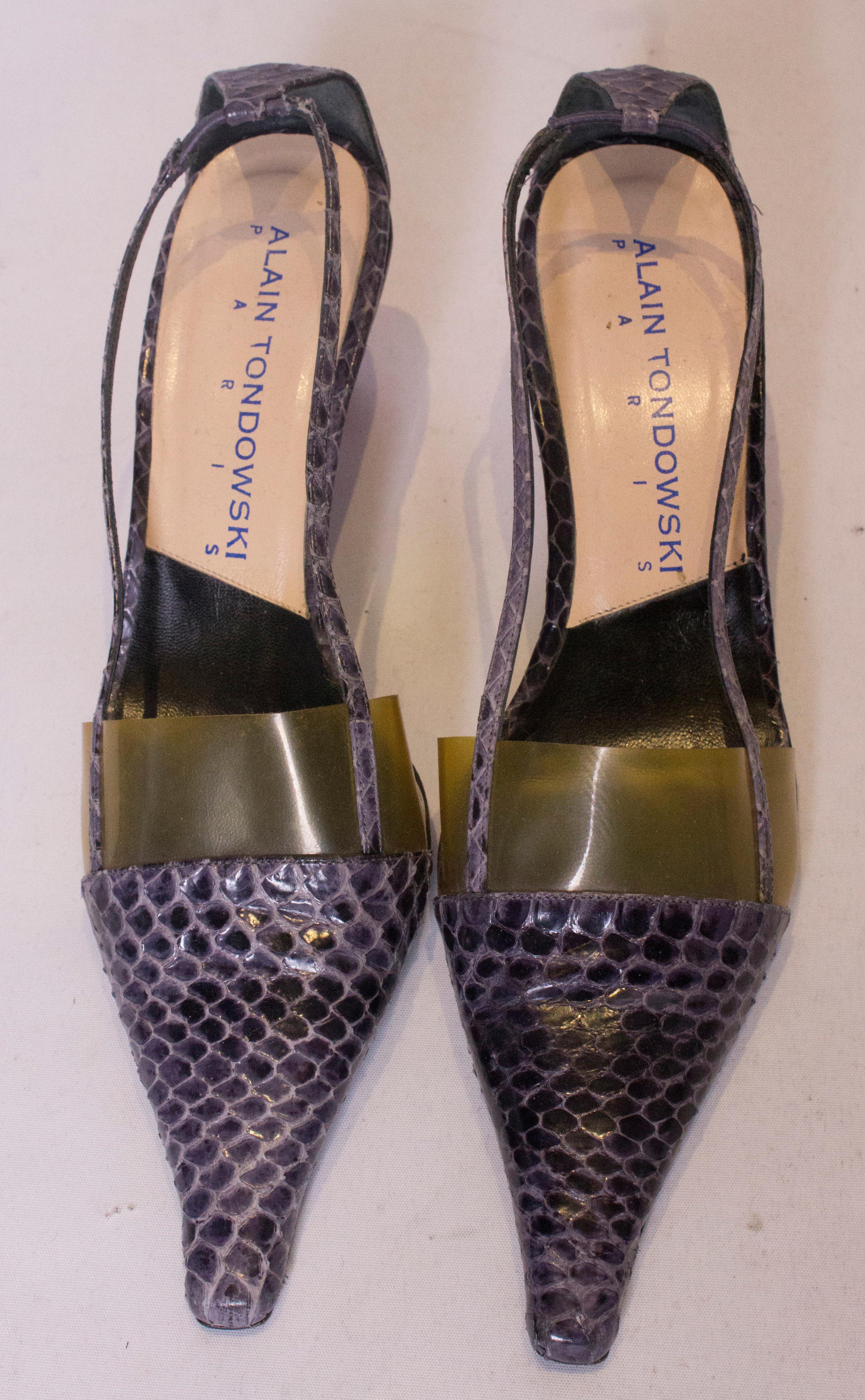 A chic pair of shoes, by Alain Tondowski. The  shoes are in a purple/grey snakeskin with chic red heels. Size 36 , heels 2  1/2''