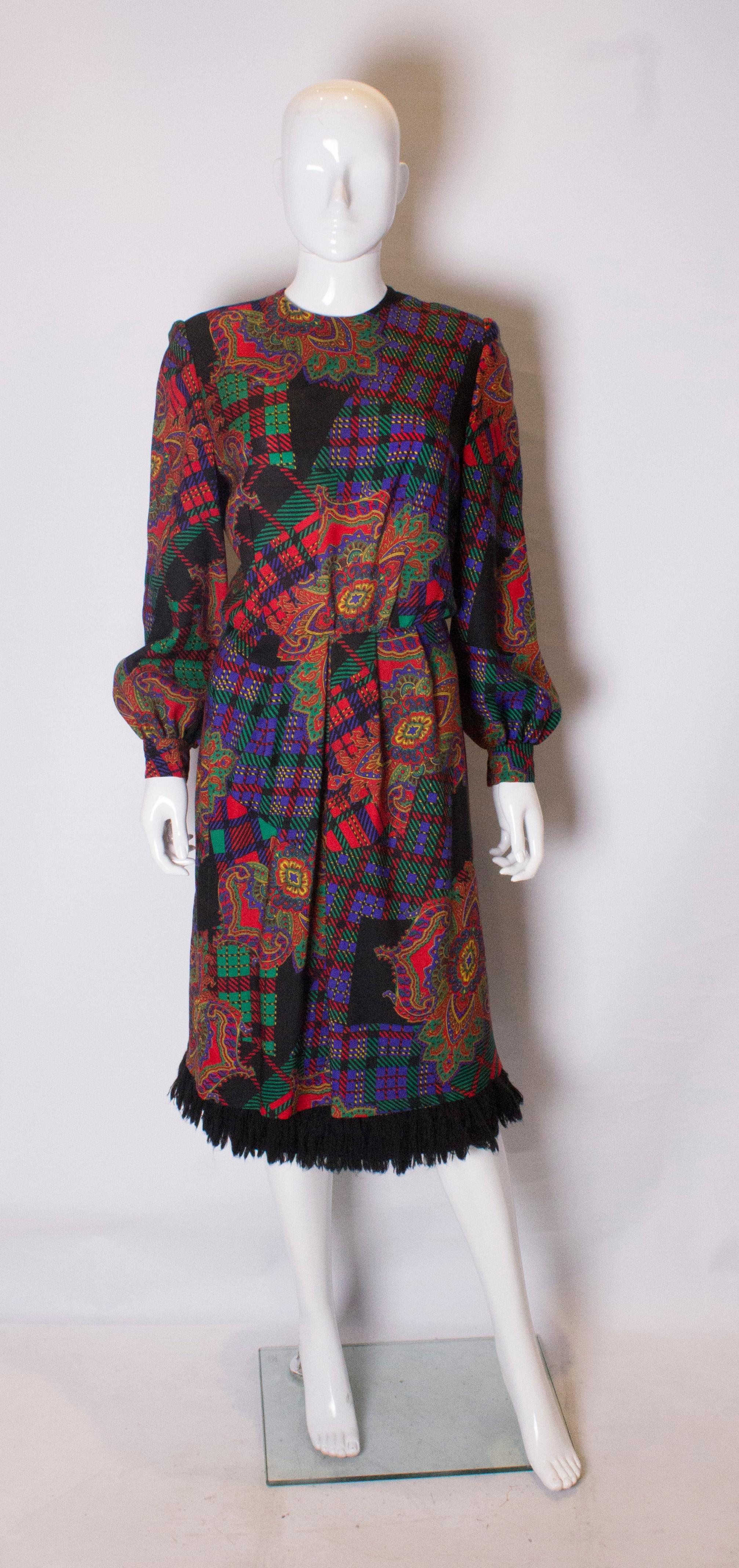 A great day dress by Donald Campbell. In a multi colour wool print, the dress has a lined skirt with pleats at the waist. It has a central back zip,popper fastening at the wrists and fringing at the hem.
Bust 38'', waist 30'', length 44''