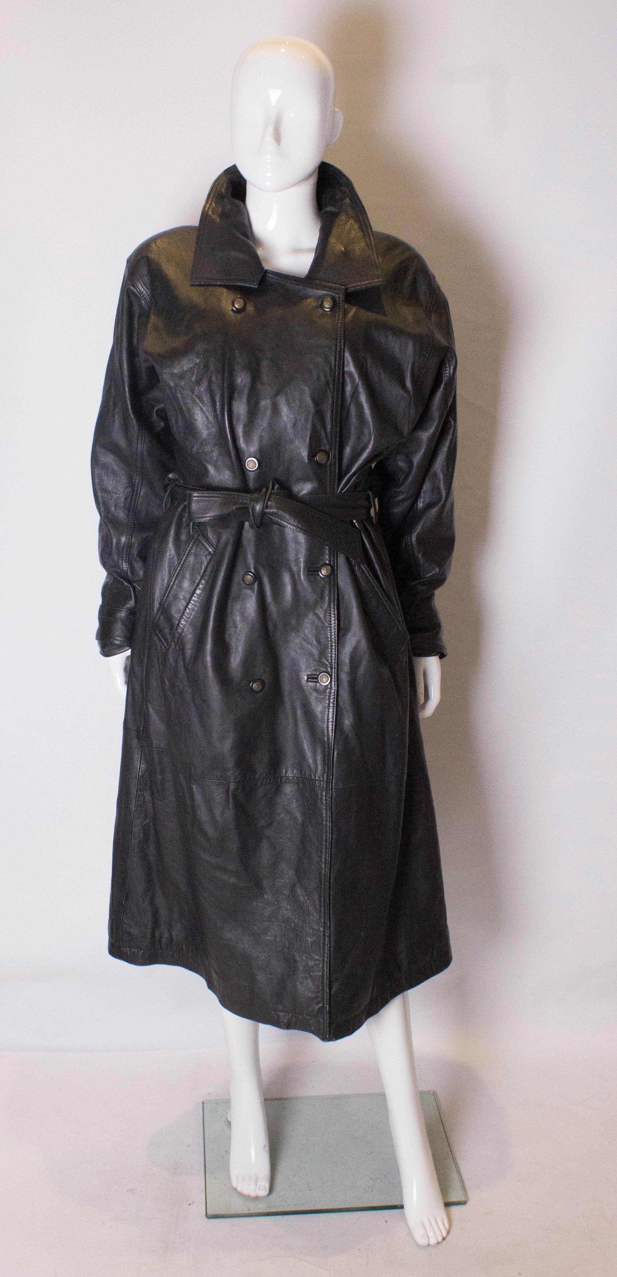 A luxurious leather trench coat . This coat is double breasted, with a two button fastening at the cuffs. It has a quilted lining, belt and back vent.