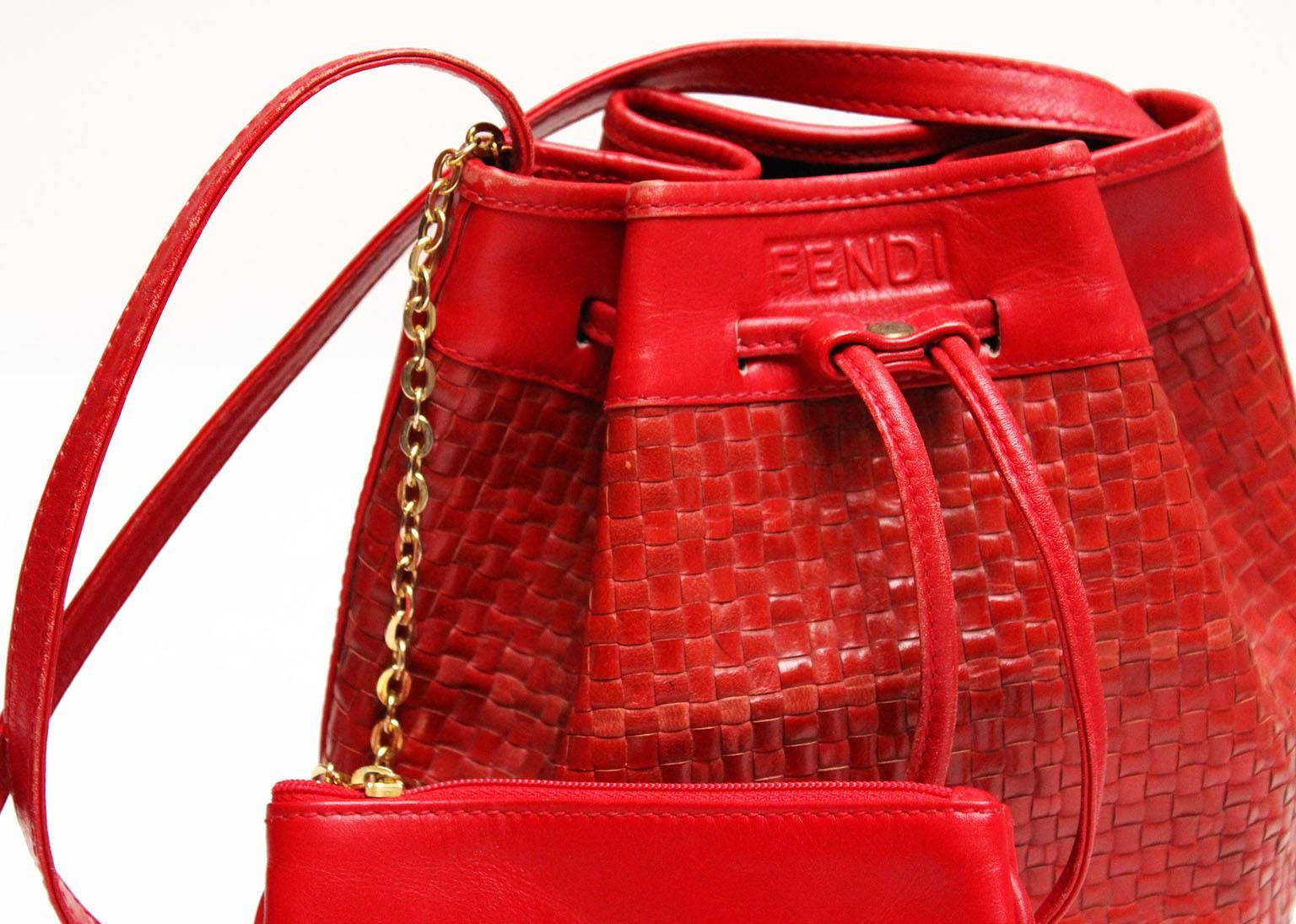 This wonderful red woven leather bag is by the famous Italian house of Fendi. The bag has an oval base with a woven leather centre, the body of the bag is woven leather with a drawstring gathering. There is a detachable leather purse ,with Fendi zip